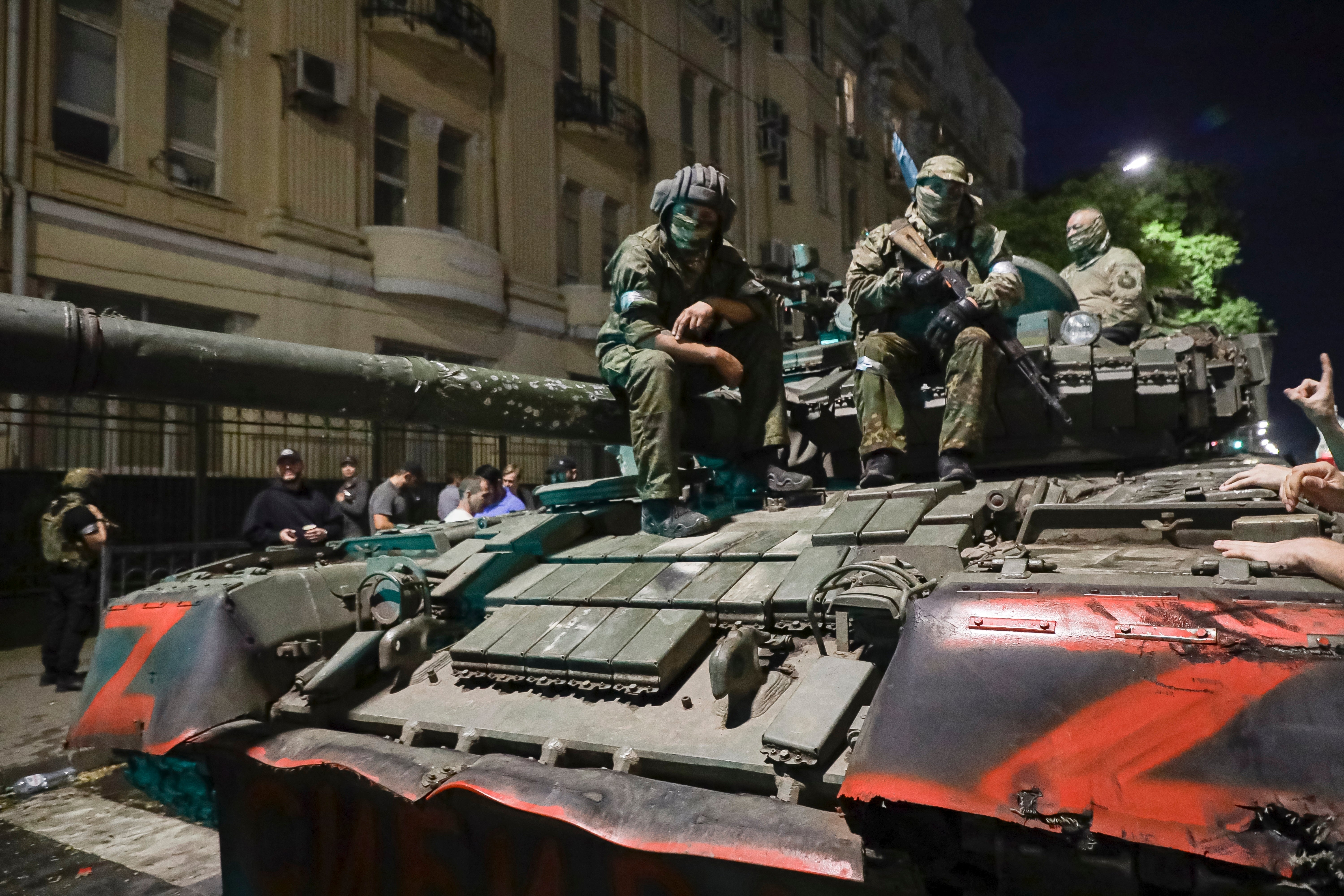 Members of the Wagner Group military company sit atop of a tank on a street in Rostov-on-Don, Russia