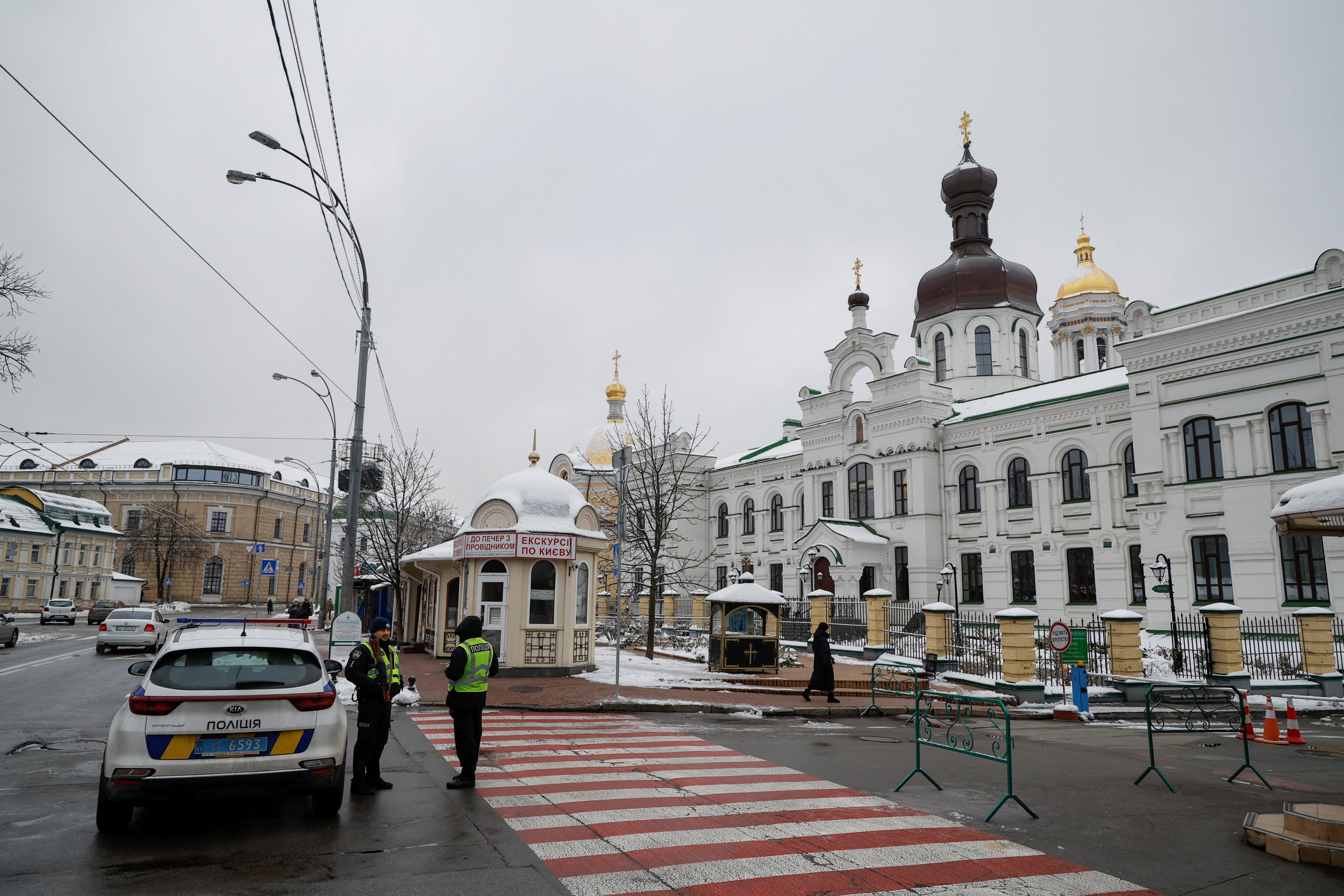 Ukrainian law enforcement officers stand next to an entrance to the Kyiv-Pechersk-Lavra monastery compound in Kyiv