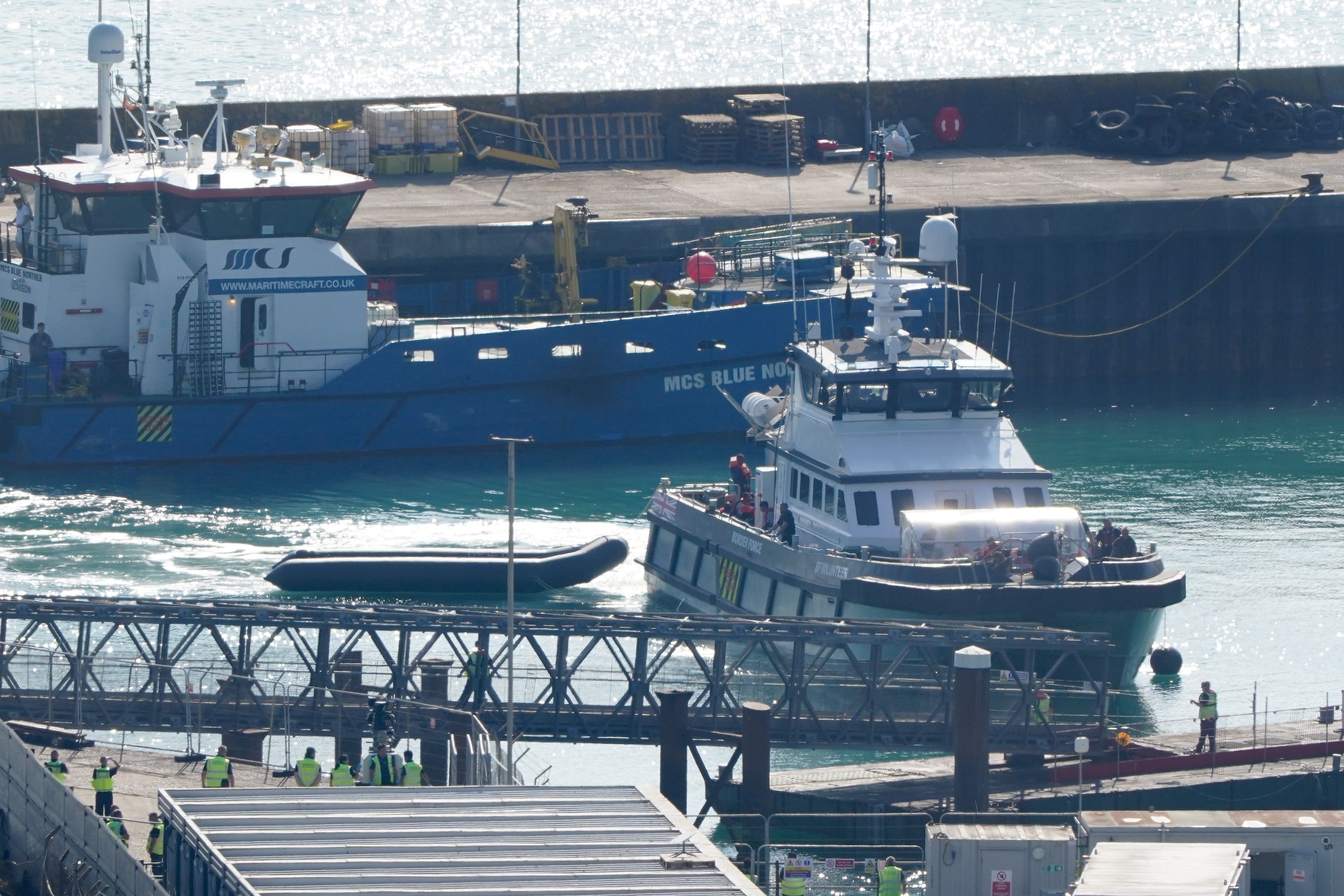 A group of people thought to be migrants are brought in to Dover, Kent, on board a Border Force vessel (PA)