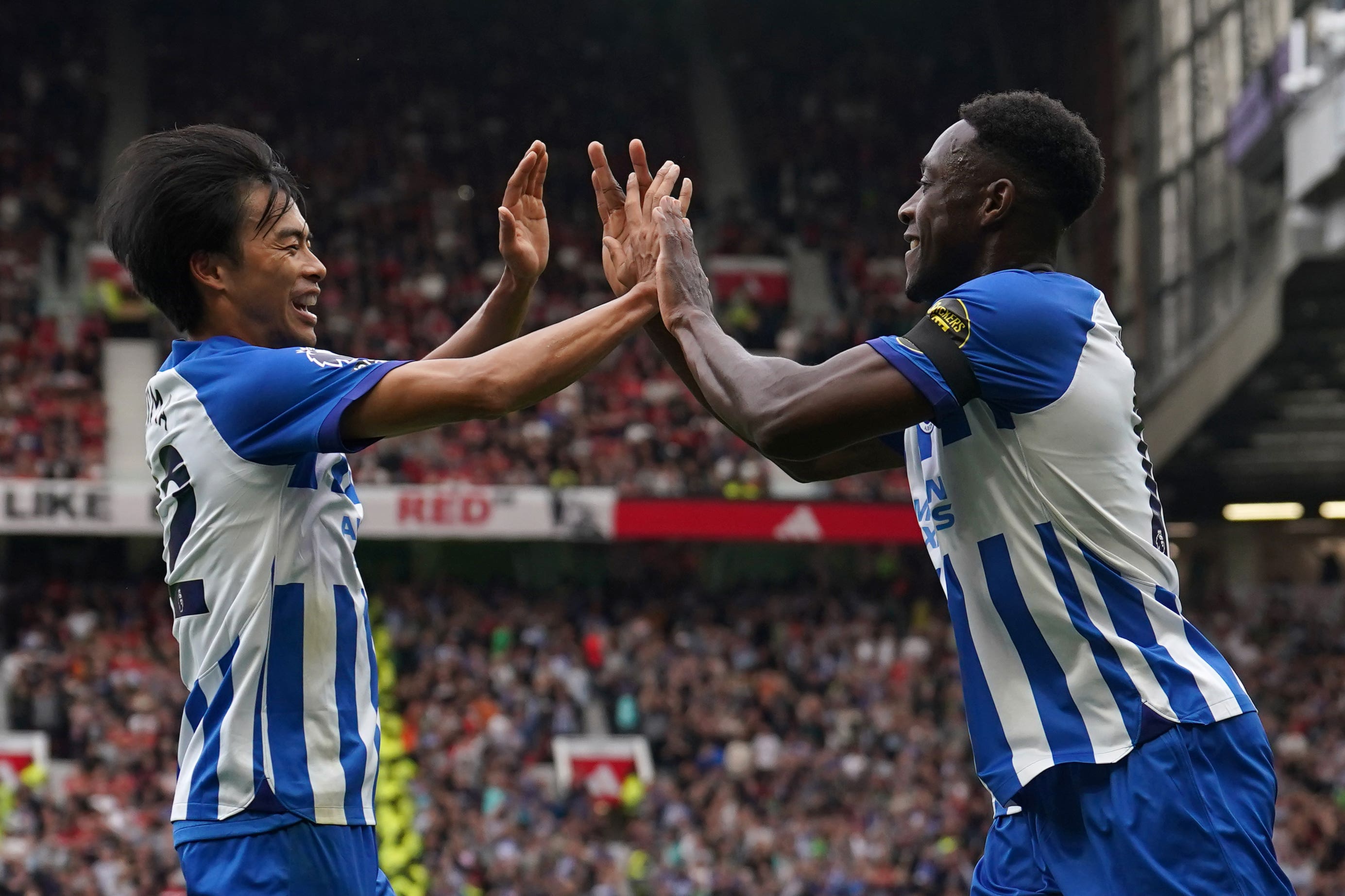 Danny Welbeck (right) celebrates with Kaoru Mitoma after scoring Brighton’s opener (Martin Rickett/PA)