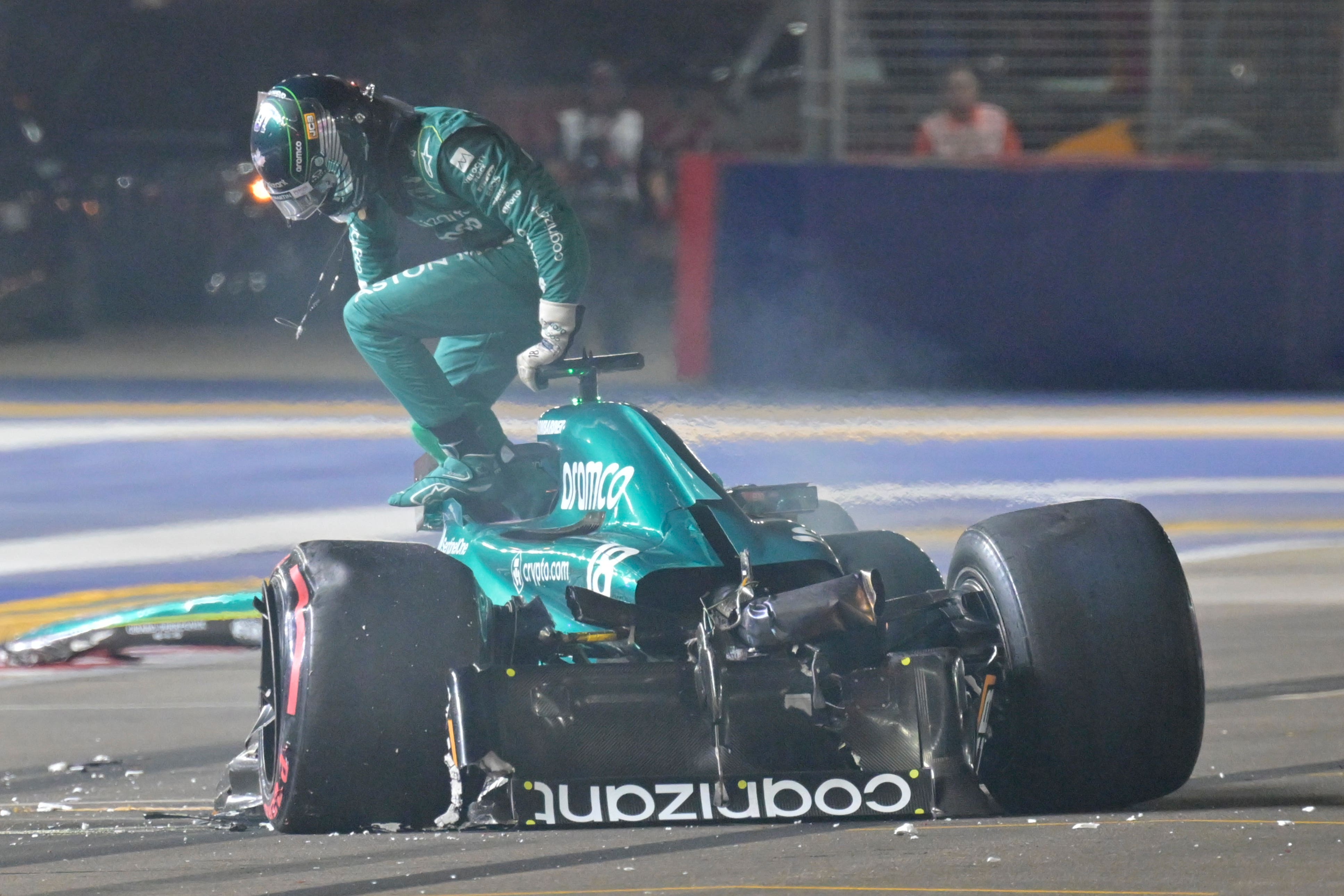 Aston Martin driver Lance Stroll emerges from his car after his crash