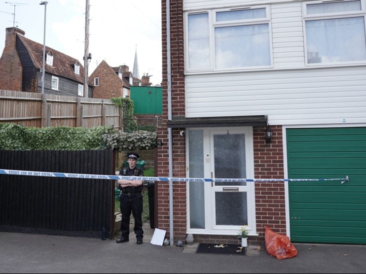 A policeman takes watch outside the house