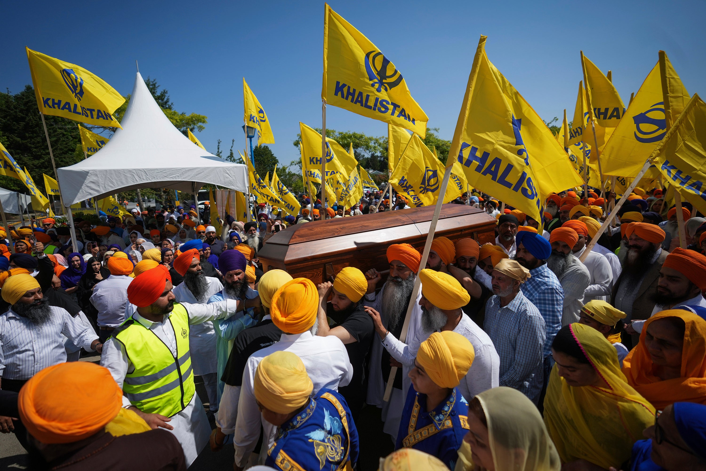 Mourners carry the casket of Sikh community leader and temple president Hardeep Singh Nijjar during Antim Darshan