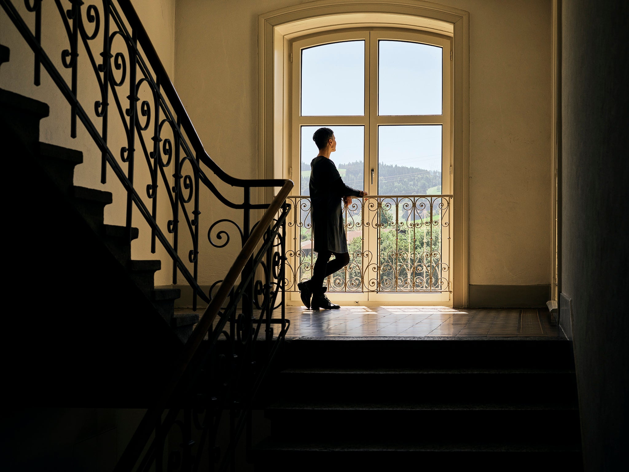 Svetlana, 44, from Irpin in Ukraine, stands on a landing of the Swiss monastery