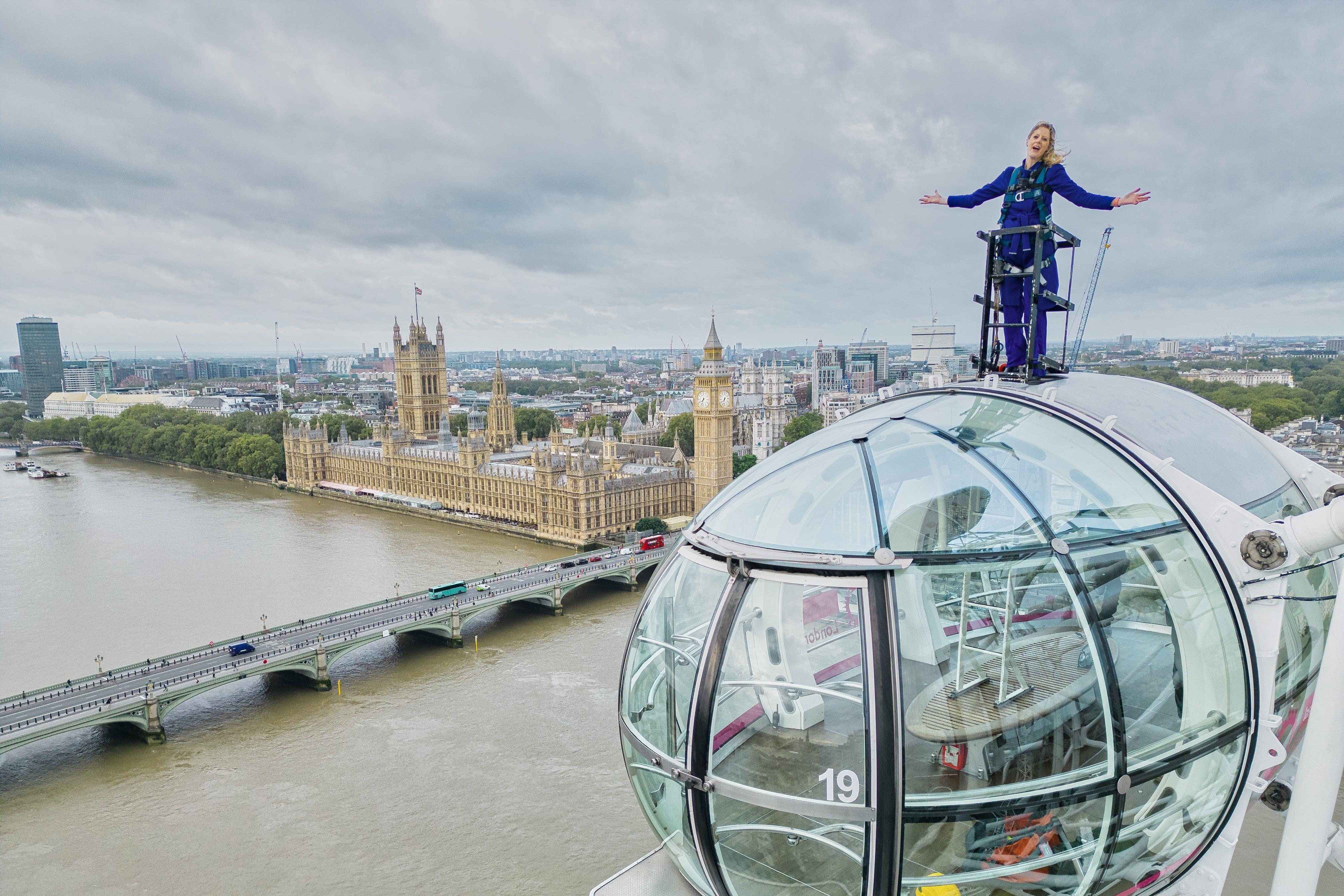 Sally Williams harnessed 135m (443ft) high on top of the London Eye for 20 minutes at 7am presenting the weather forecast (ITV News London/PA)