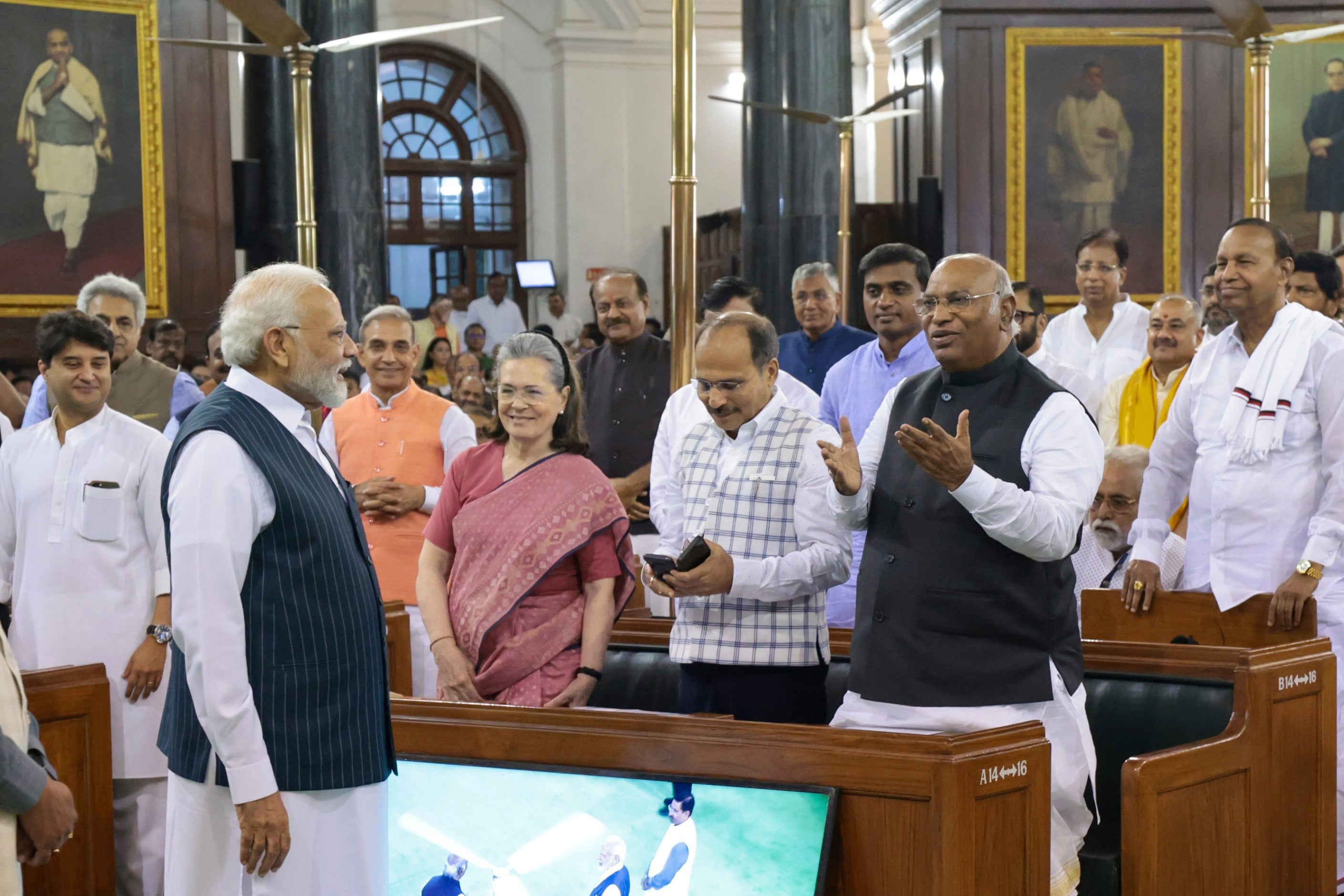 This Handout photograph released by the Press Information Bureau shows Indian Prime Minister Narendra Modi talking to Congress party President Mallikarjun Kharge, right, with senior leaders Sonia Gandhi and Adhir Ranjan Chowdhury standing beside