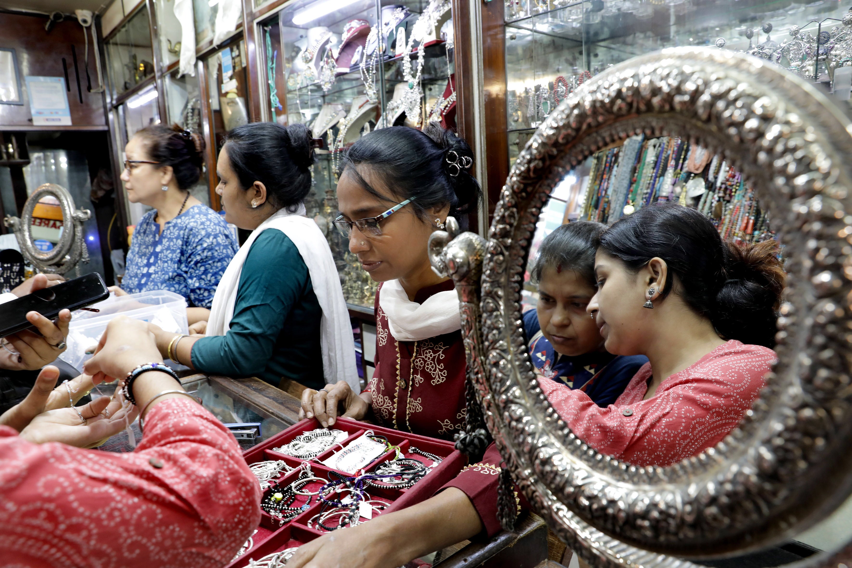 Staff assist customers at a jewelry store at New Market in Kolkata on 19 September