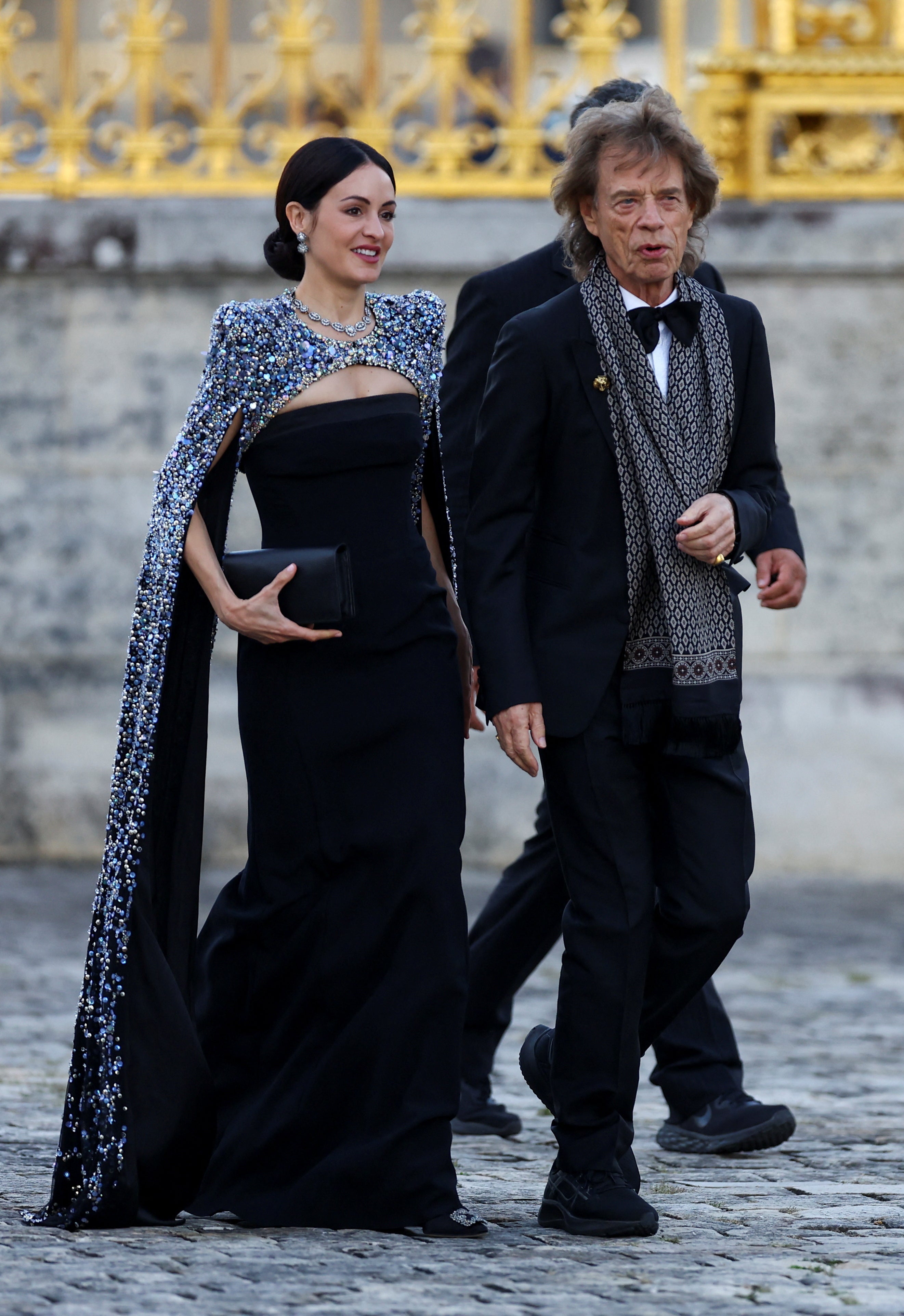 Rolling Stones band member Mick Jagger and Melanie Hamrick arrive to attend a state dinner in honor of Britain's King Charles and Queen Camilla at the Chateau de Versailles