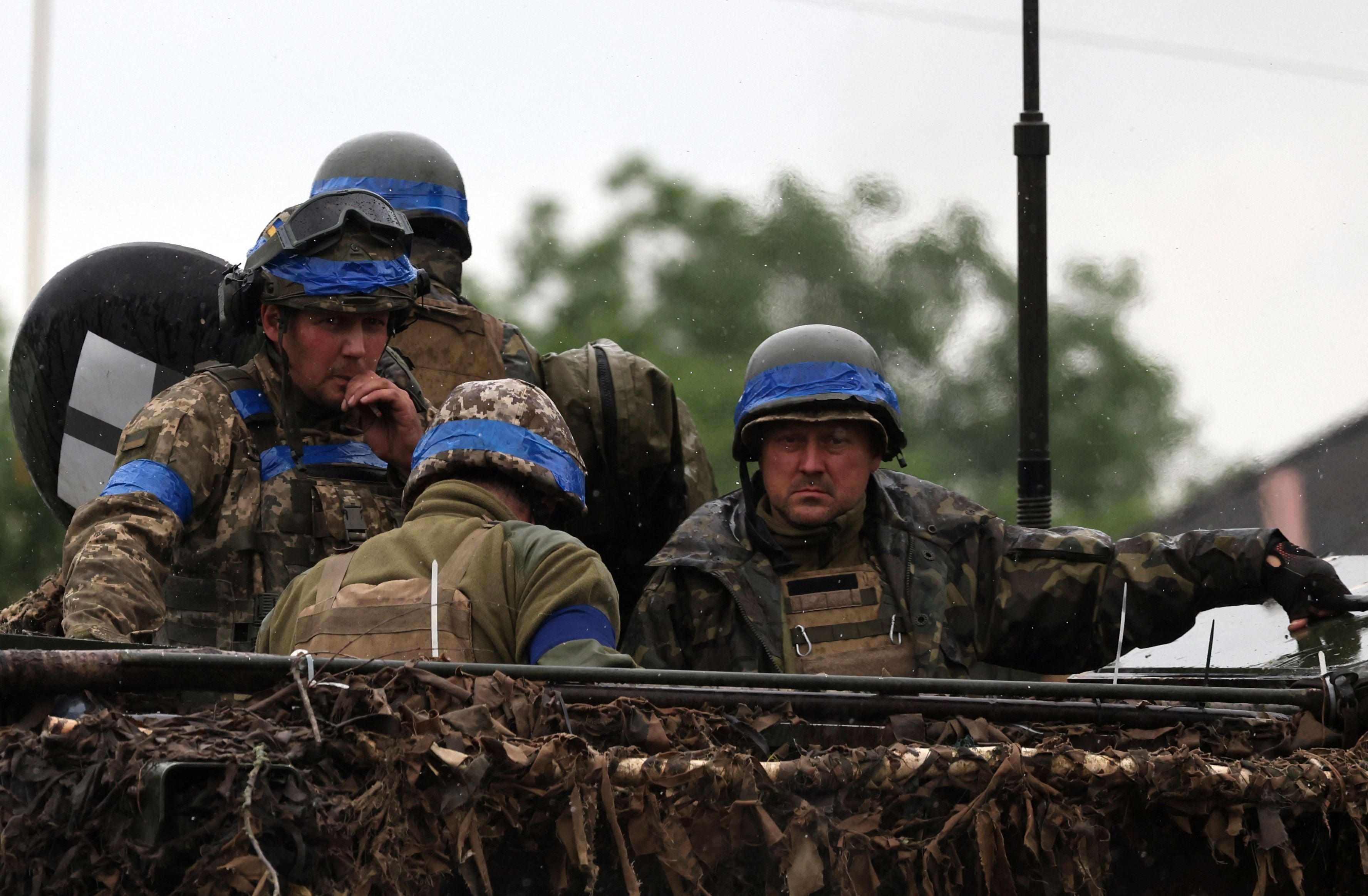 File: Ukrainian servicemen ride atop an armoured personnel carrier vehicle (APC) in the Zaporizhzhia region