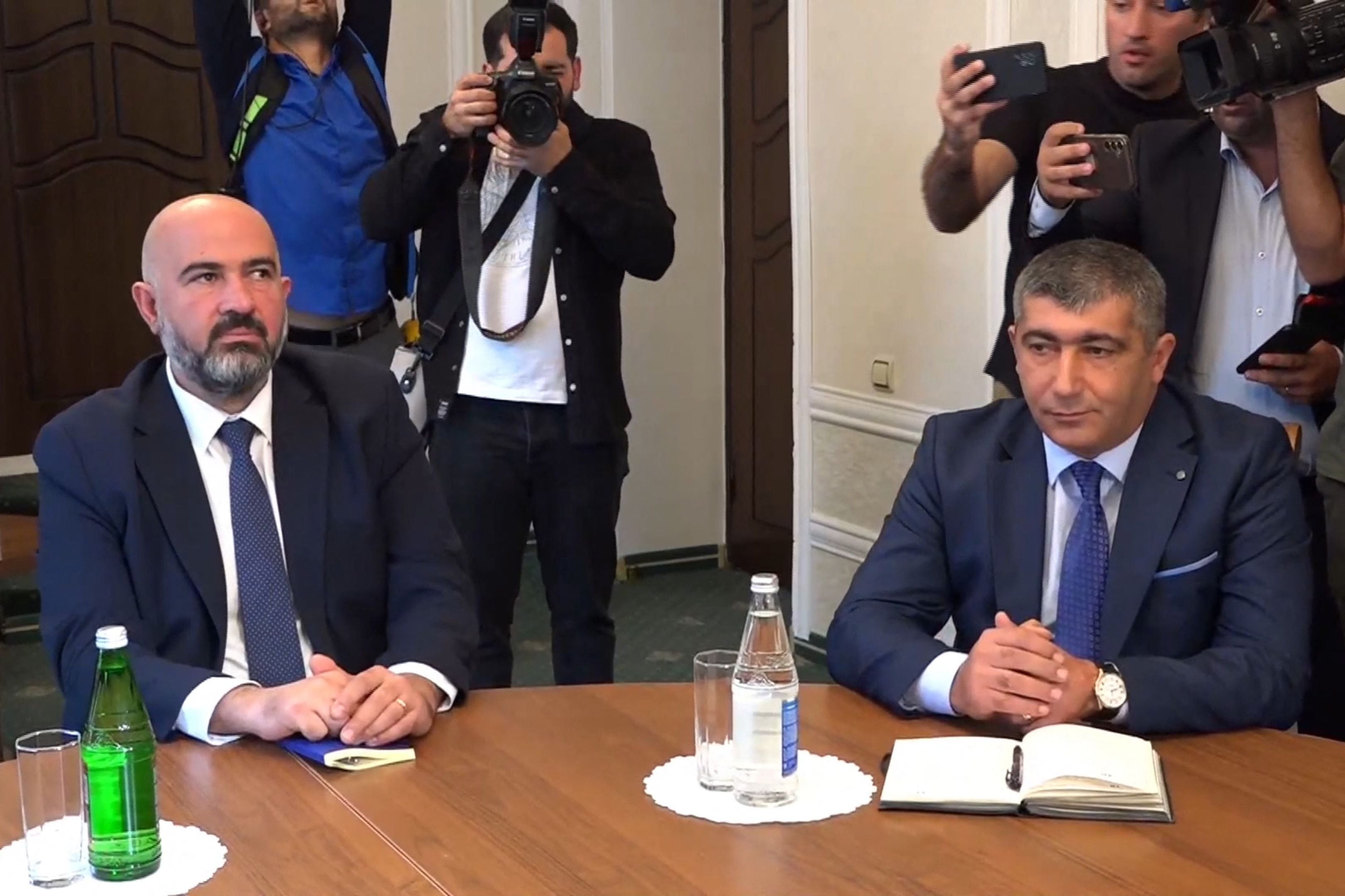 Deputy of the National Assembly of the Nagorno-Karabakh David Melkumyan, left, attends talks with Azerbaijani delegation in the Azerbaijani town of Yevlakh