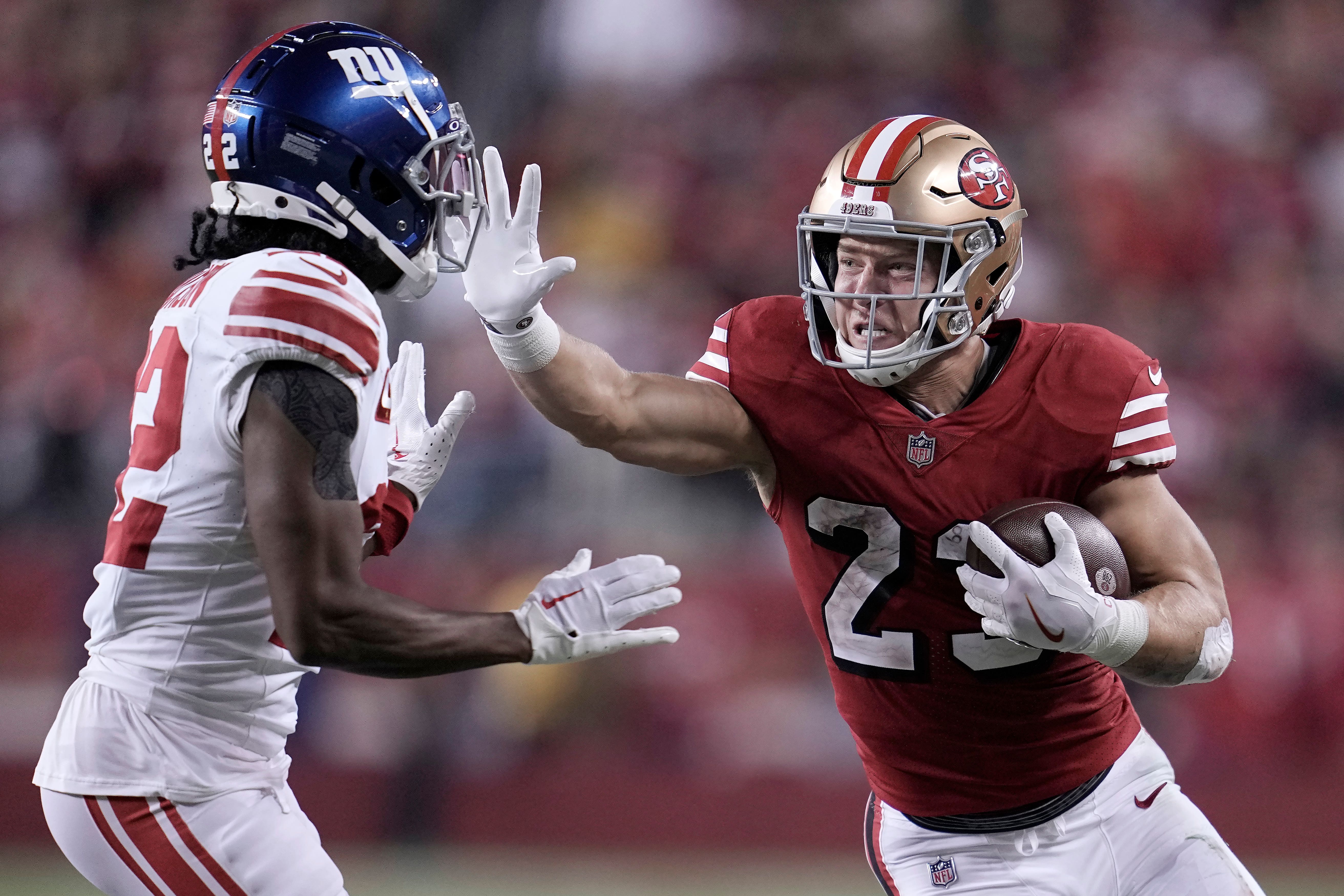 San Francisco 49ers running back Christian McCaffrey, right, runs against New York Giants cornerback Adoree’ Jackson (Godofredo A Vásquez/AP)