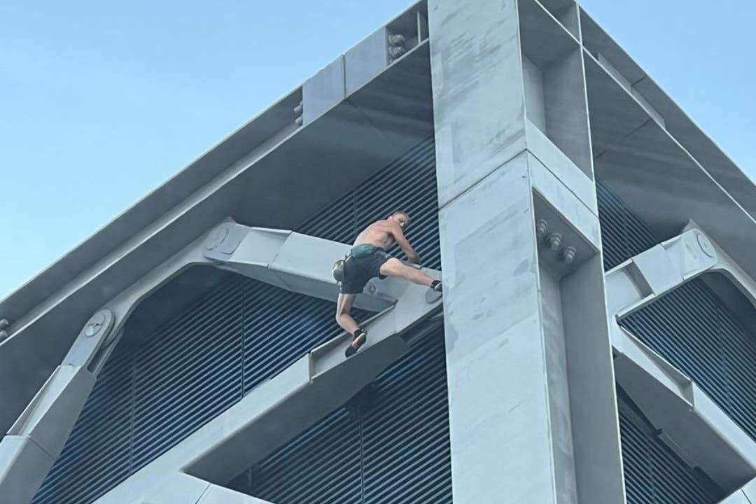 A shirtless man climbing the Cheesegrater in London (Theo Livesey/PA)