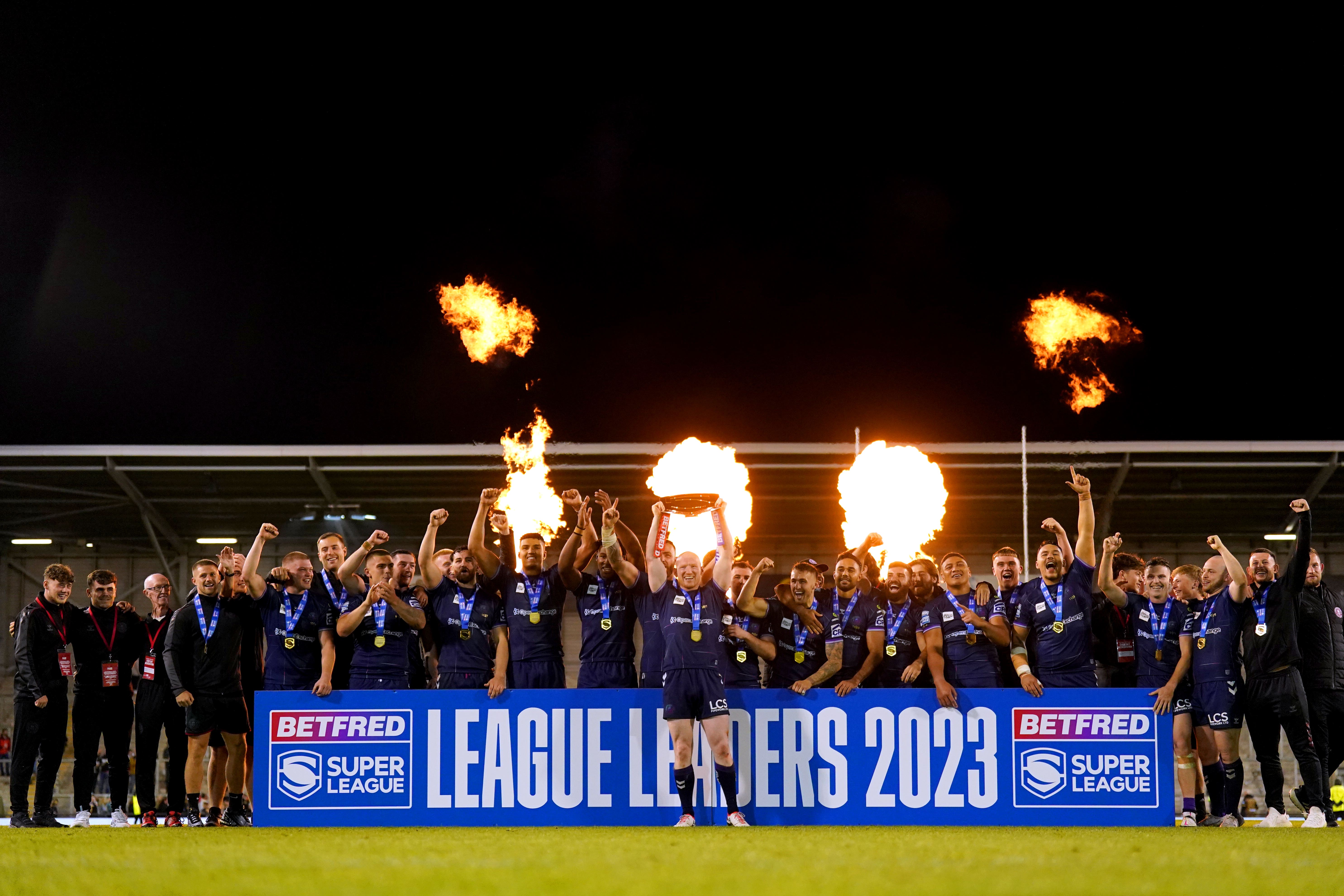 Wigan celebrate winning the League Leaders Shield (Tim Goode/PA)