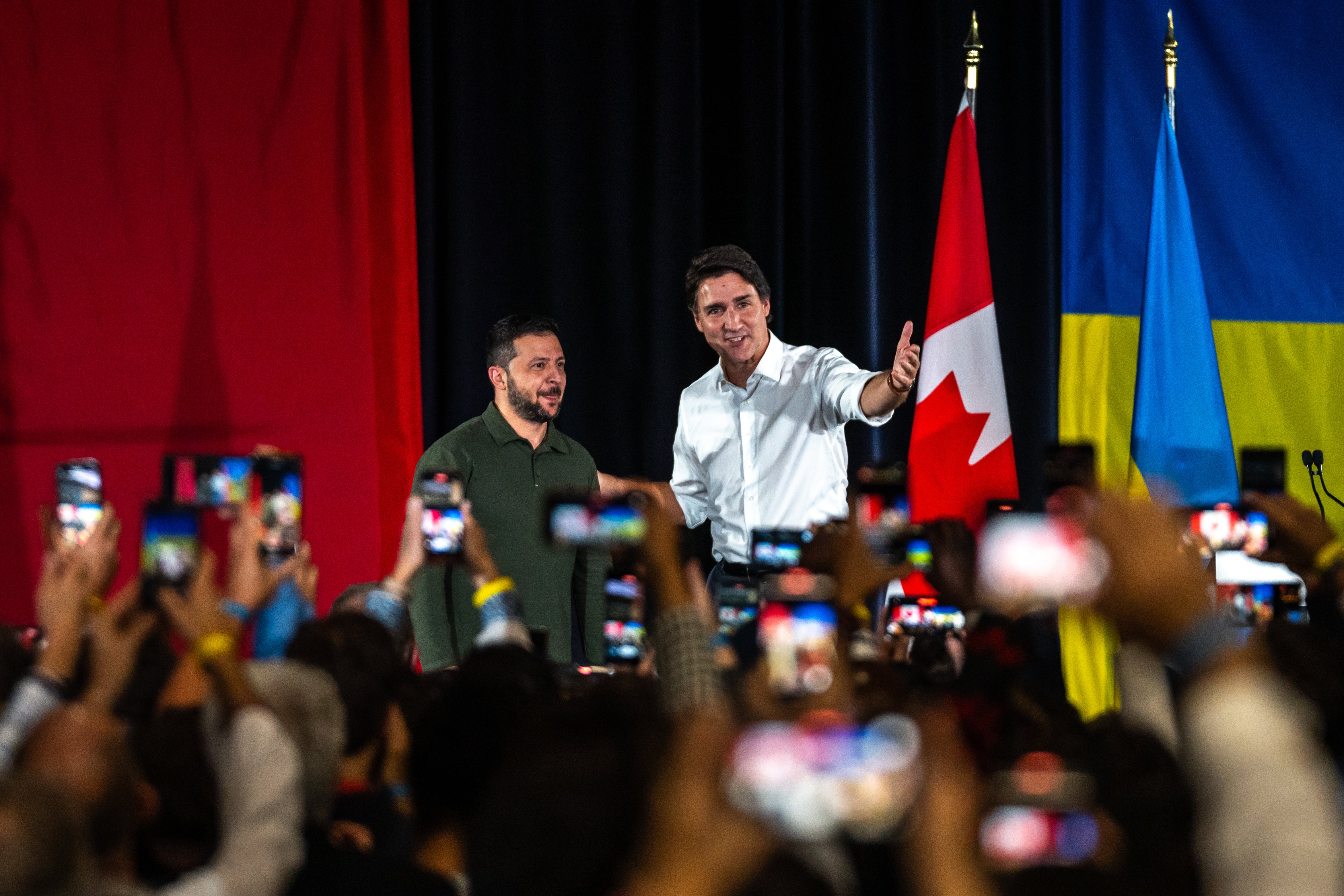 Canadian prime minister Justin Trudeau (R) and Ukrainian president Volodymyr Zelensky interact on stage during a rally at Fort York in Toronto, Canada