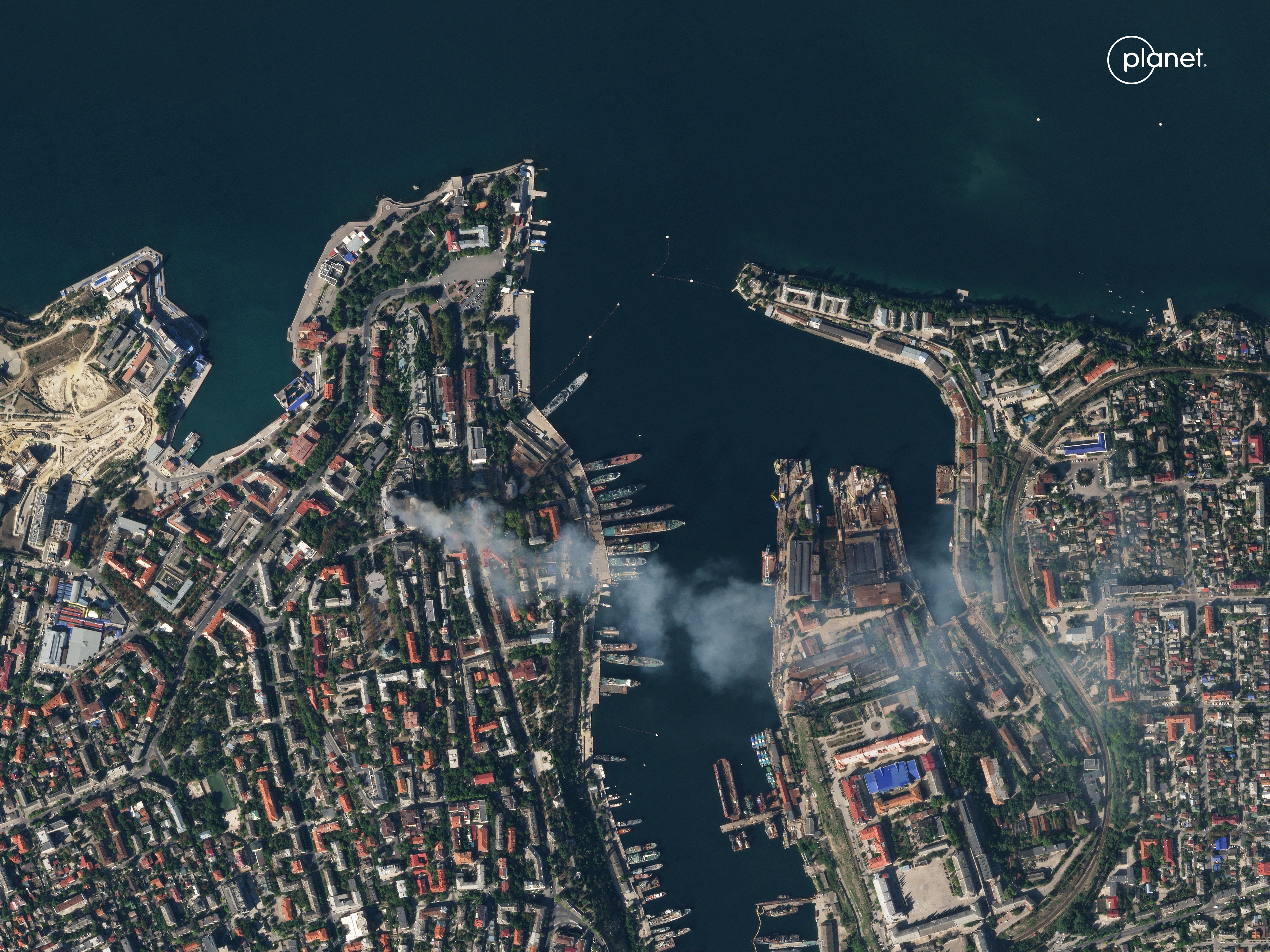 A satellite image shows smoke billowing from a Russian Black Sea Navy HQ after a missile strike