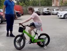 Heartwarming moment Russian bomb victim, 6, learns to ride bike again