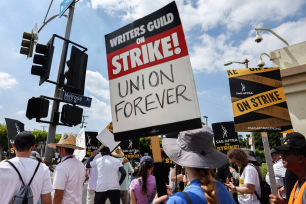 Striking WGA (Writers Guild of America) members picket with striking SAG-AFTRA members outside Paramount Studios on 18 September 2023 in Los Angeles