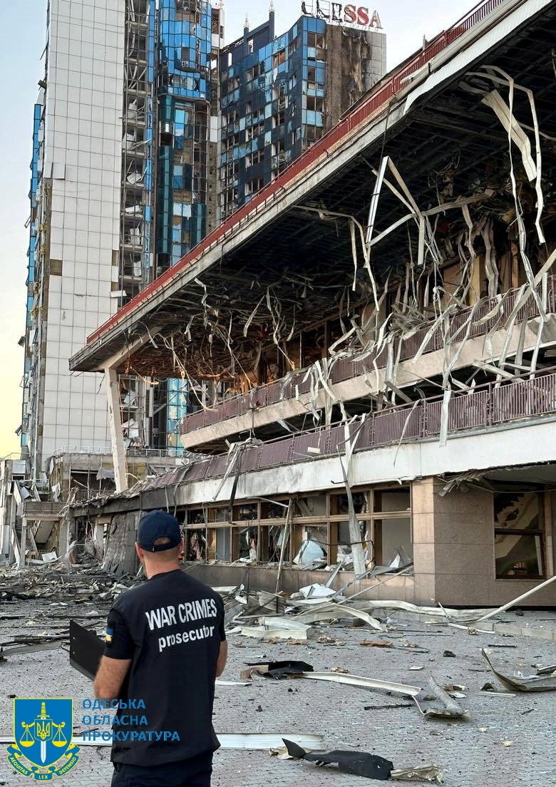 A member of Odesa Regional Prosecutor's Office personnel inspects damage following a Russian military attack,