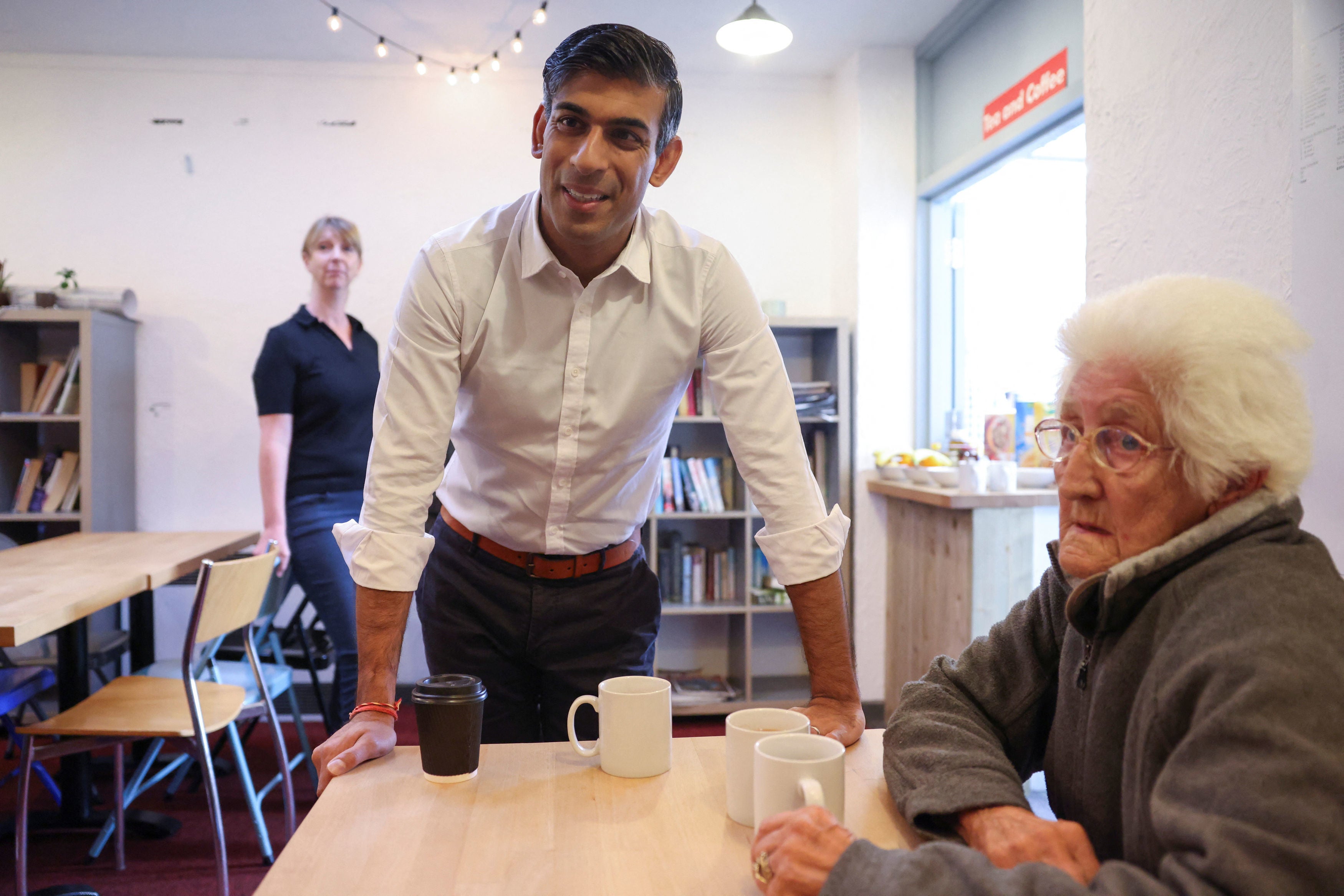 Sunak meets Christine Tadgell, 77, a member of the community attending a breakfast club at Wormley, Herfordshire