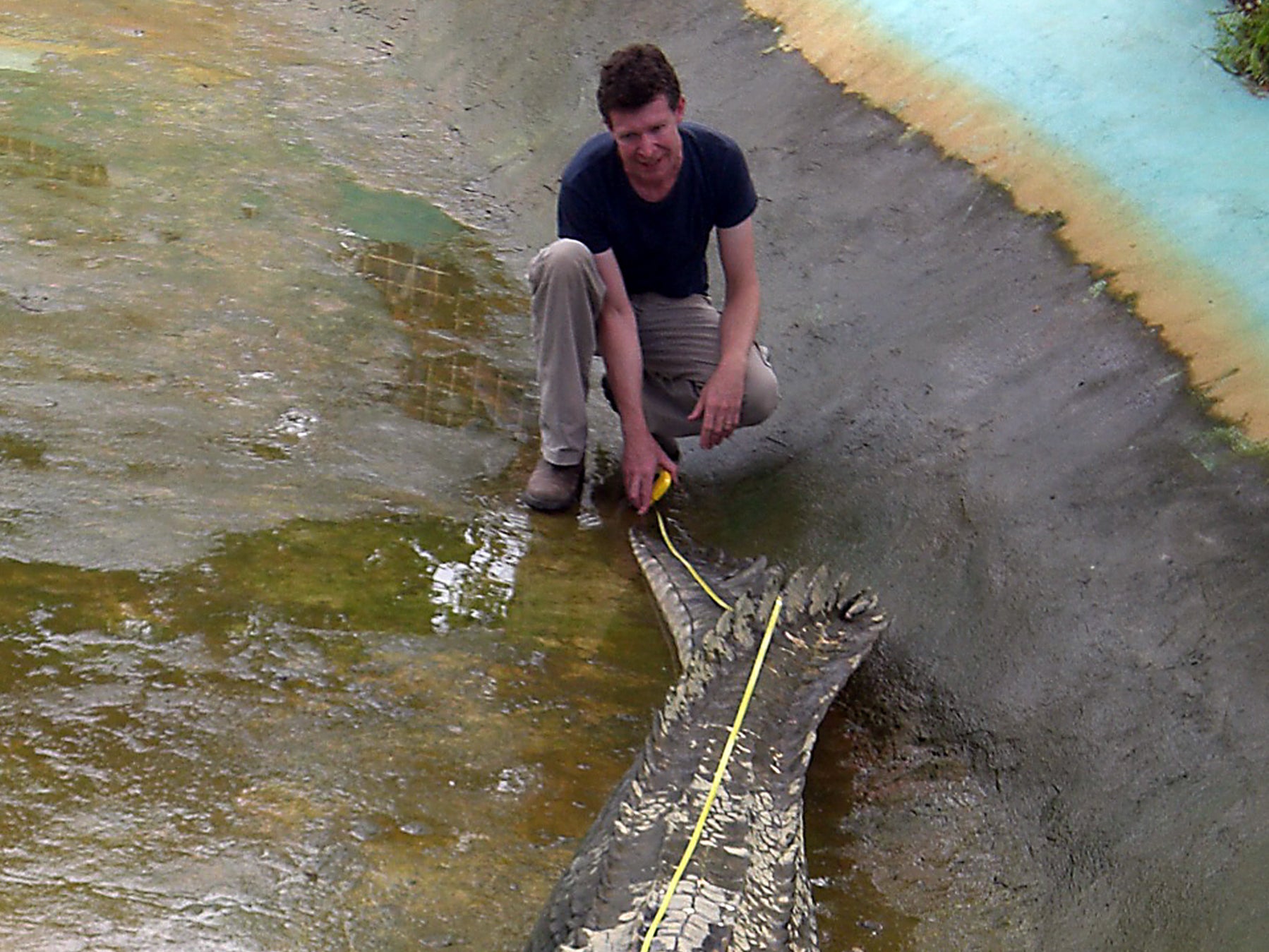 Adam Britton measures a captive crocodile on the Philippines island of Mindanao in 2011