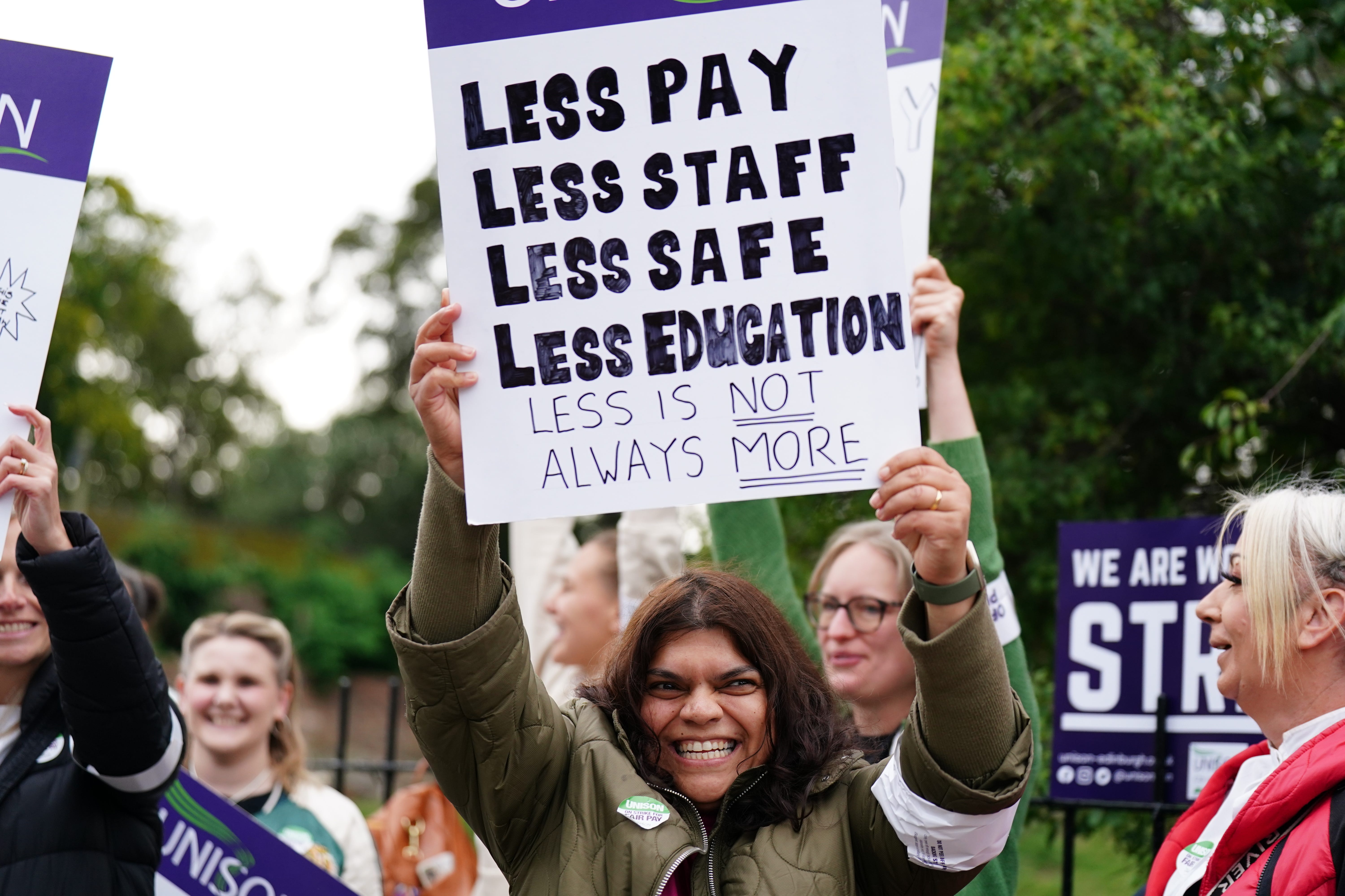 Essential school staff including cleaners, janitors and support workers have been locked in a pay dispute (Jane Barlow/PA)