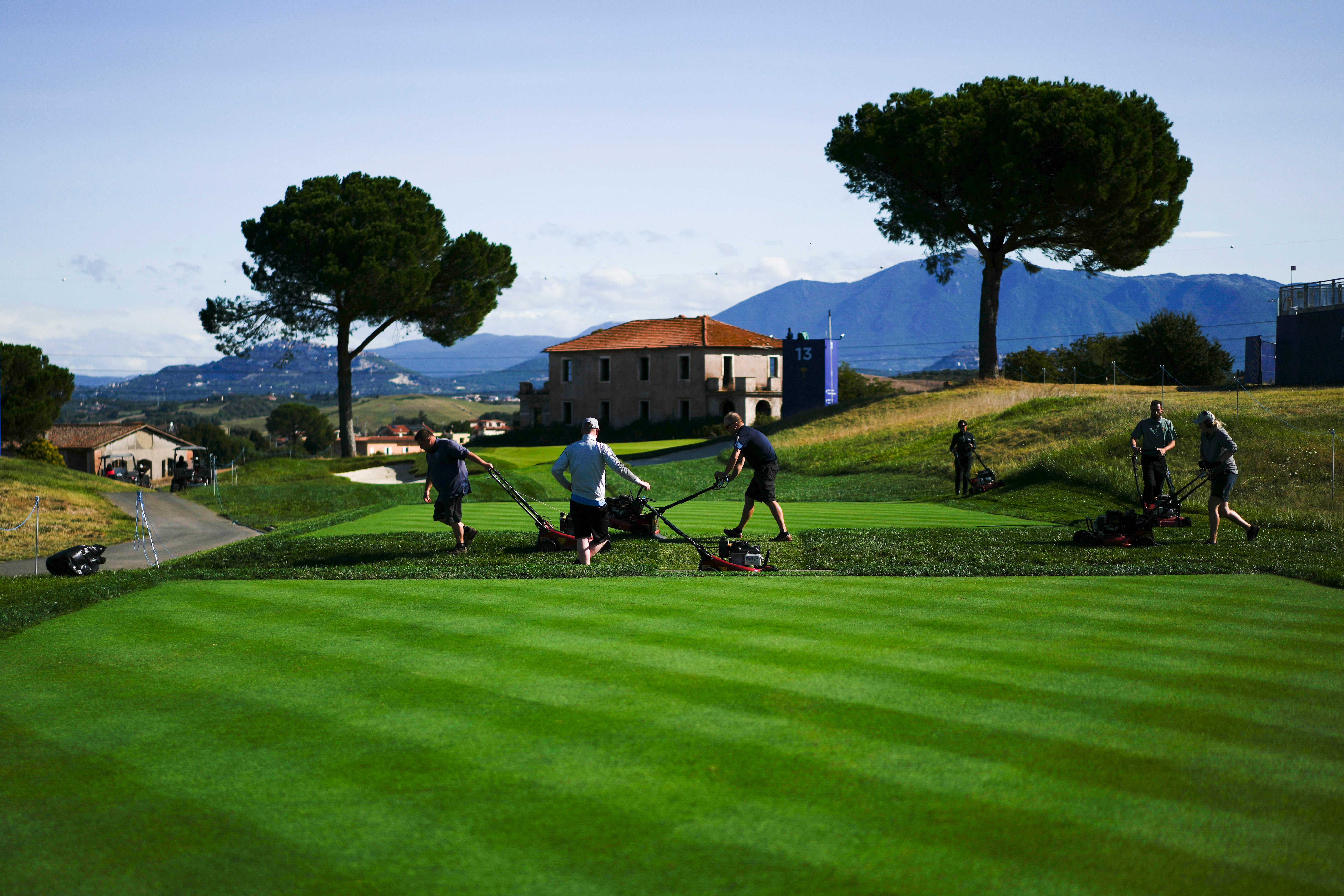 Greenskeepers prepare the ground for the Ryder Cup at Marco Simone Golf Club