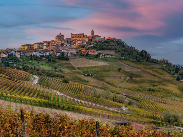 <p>Terracotta hilltop towns overlook sprawling vineyards in the Piedmont region of Italy </p>