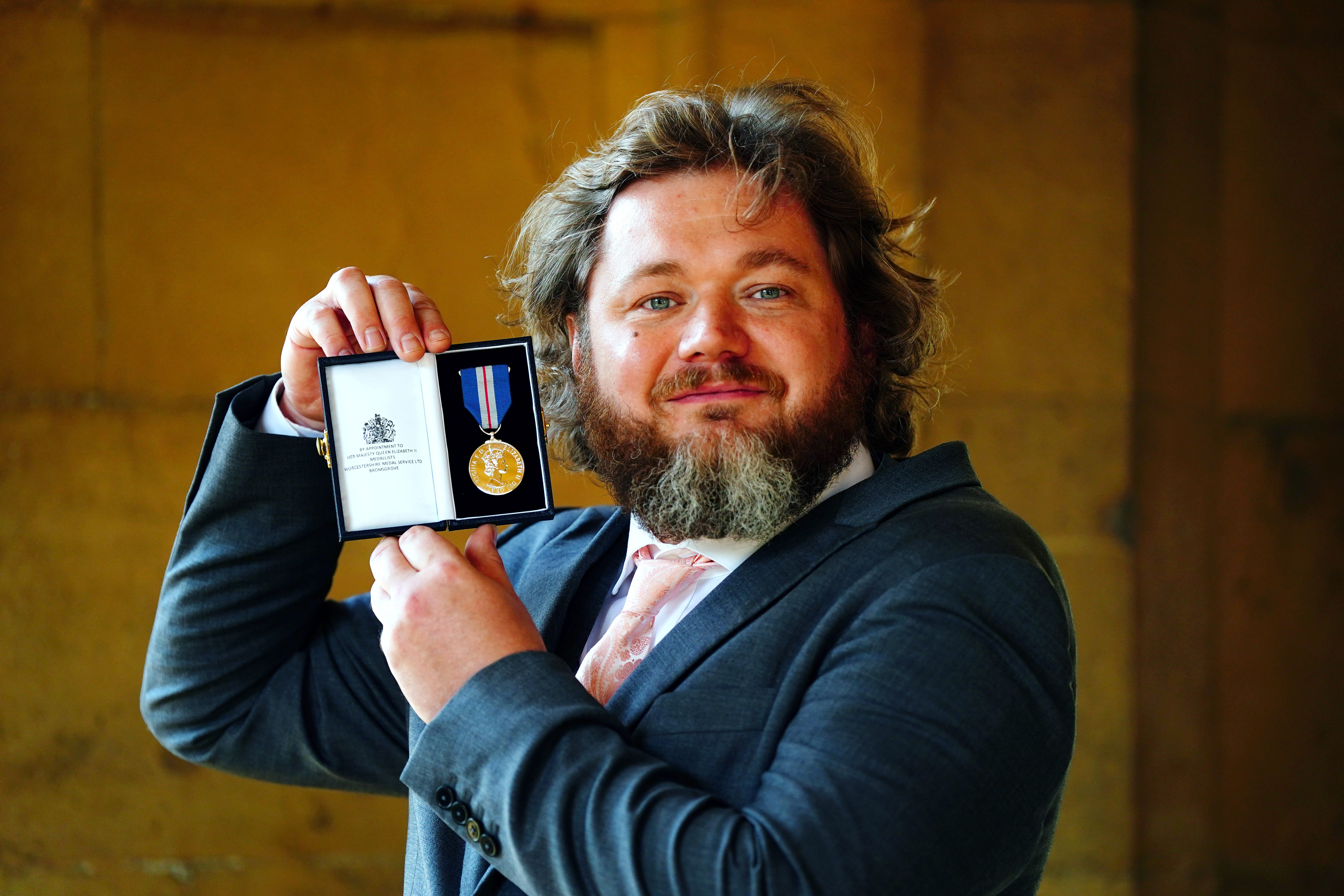 Lukasz Koczocik shows off his Queen’s Gallantry medal (Victoria Jones/PA)