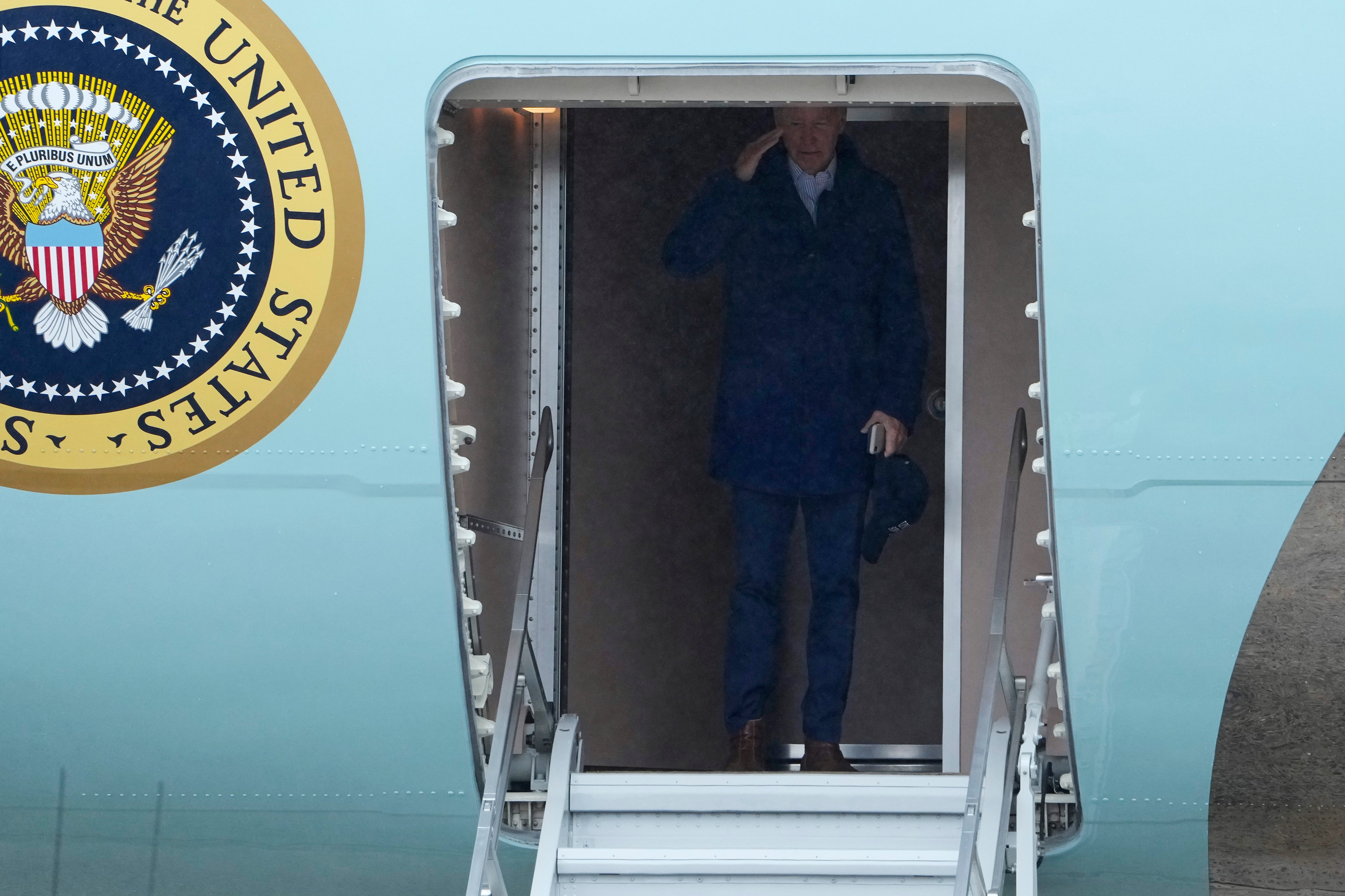 President Joe Biden returns a salute as he boards Air Force One for a trip to Michigan to join striking United Auto Workers on the picket line