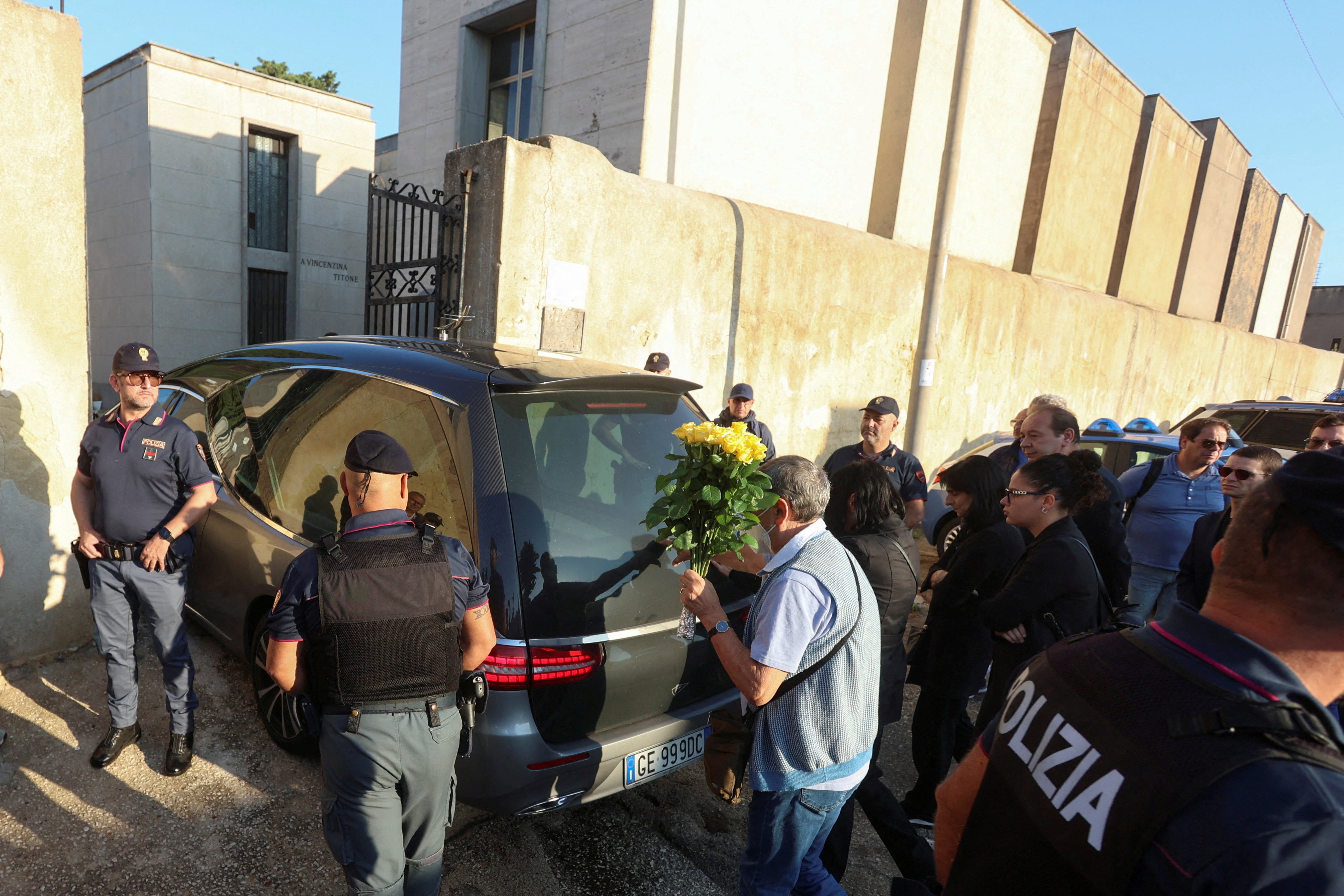 Police surround the hearse carrying Messina Denaro