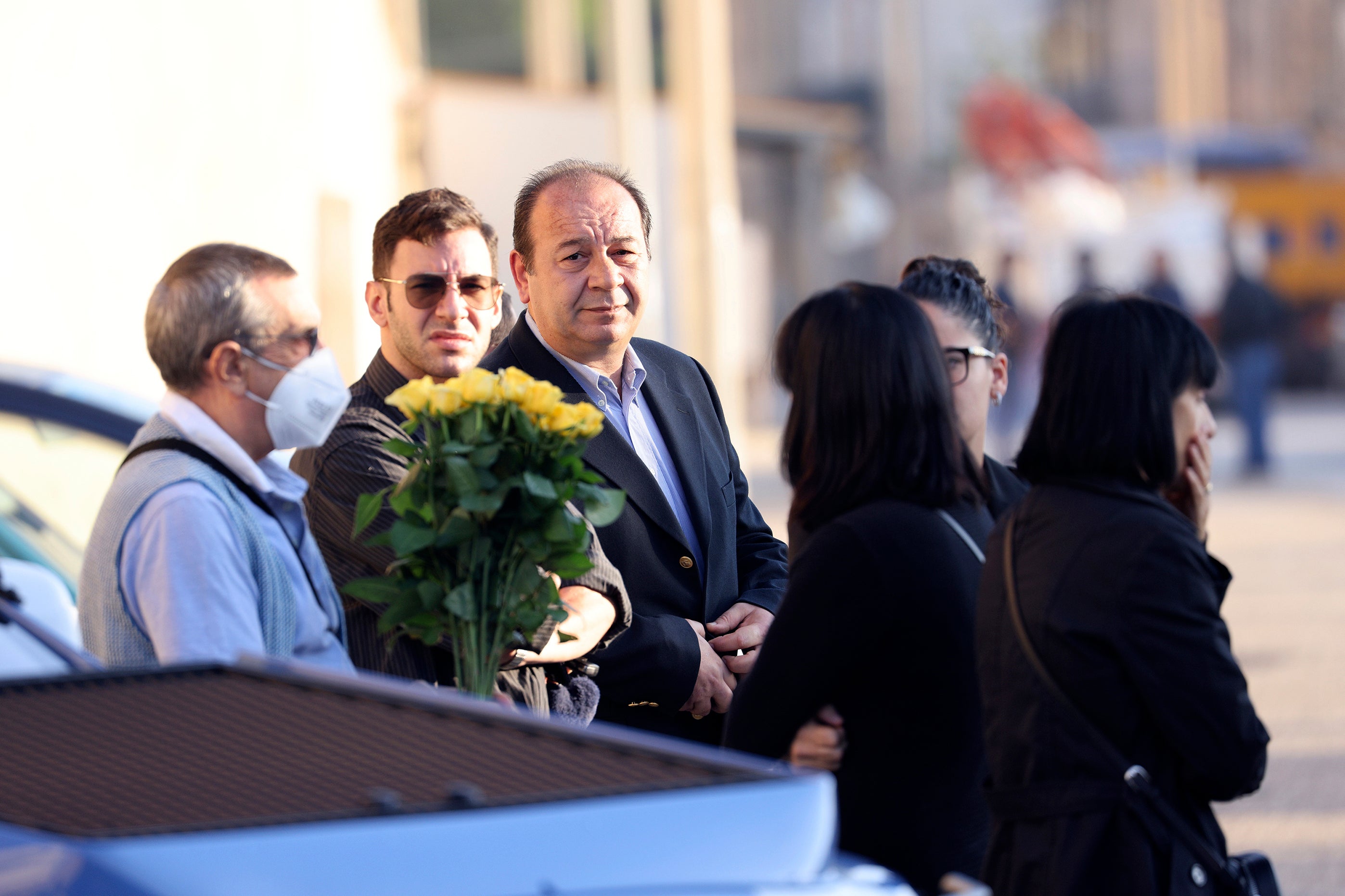 Relatives of late Mafia boss Matteo Messina Denaro, including his brother Salvatore, holding flowers at left, and sister Bice, right, wait for Denaro's funeral hearse to arrive