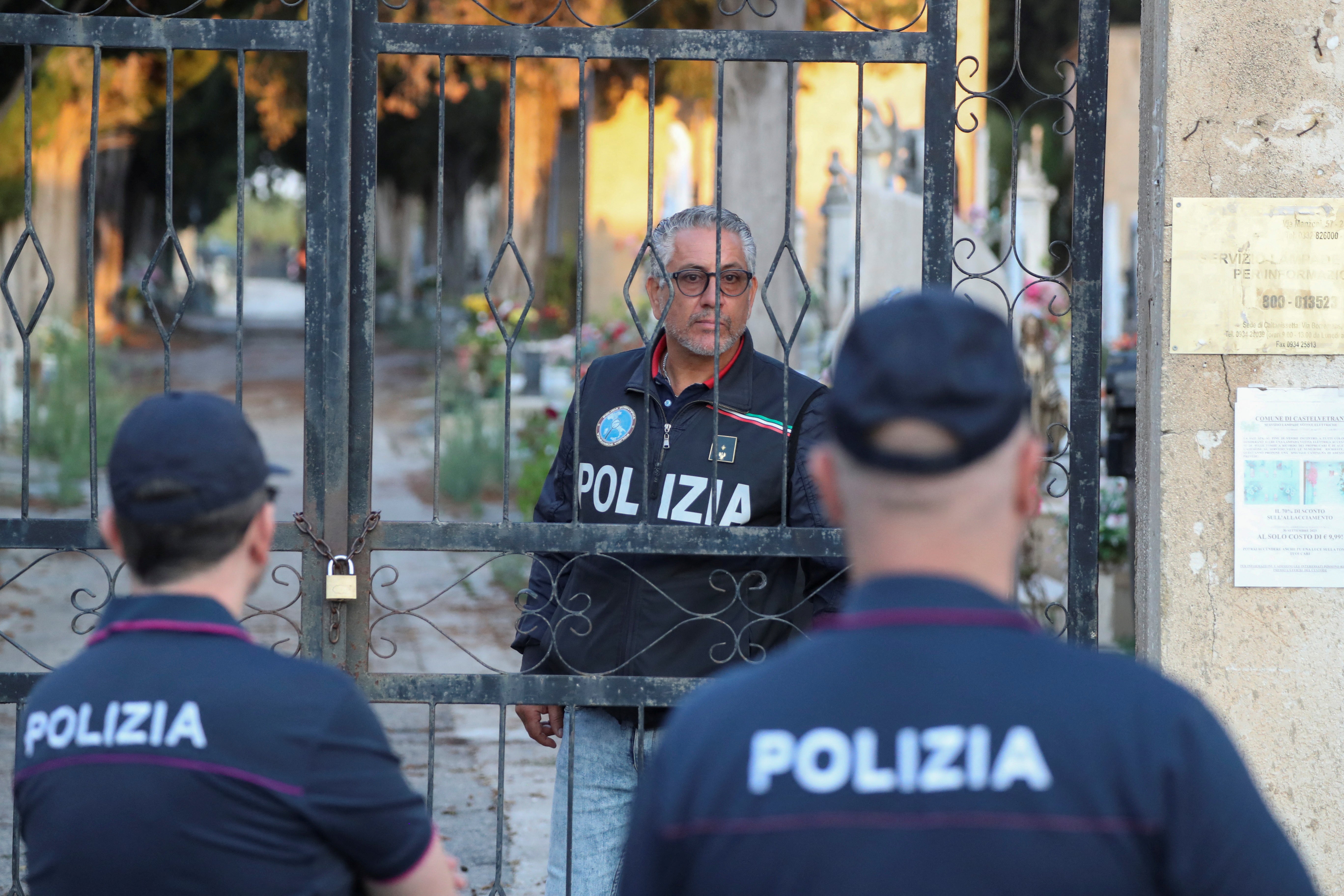 Police stand outside the cemetery, where late mafia boss Matteo Messina Denaro is burie