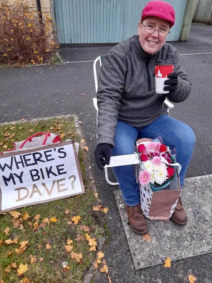 Fiona Bateman outside David Seagar’s house with placard reading ‘Where’s My Bike Dave?'