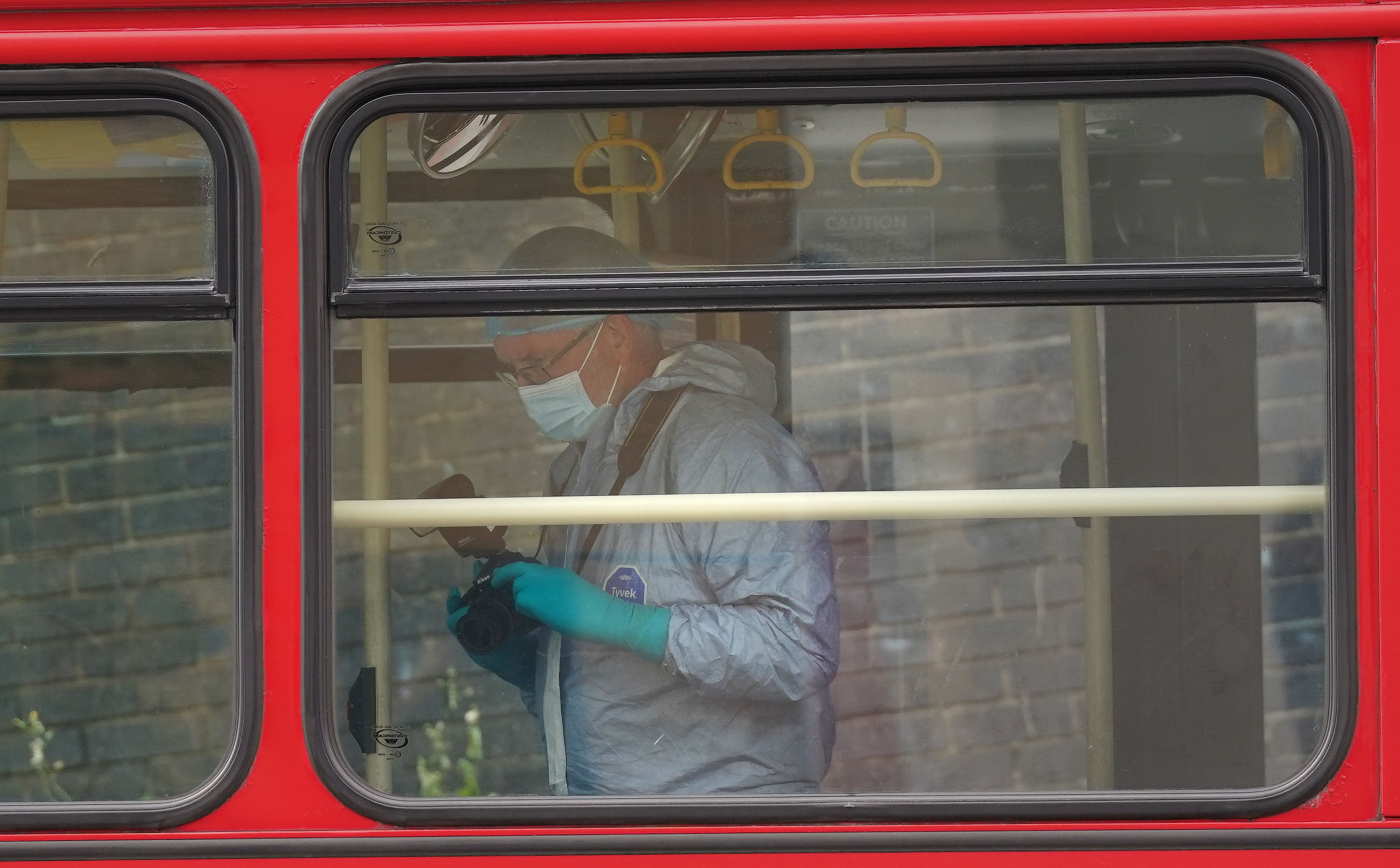 Forensic investigators examining the bus after a 15-year-old girl was stabbed to death