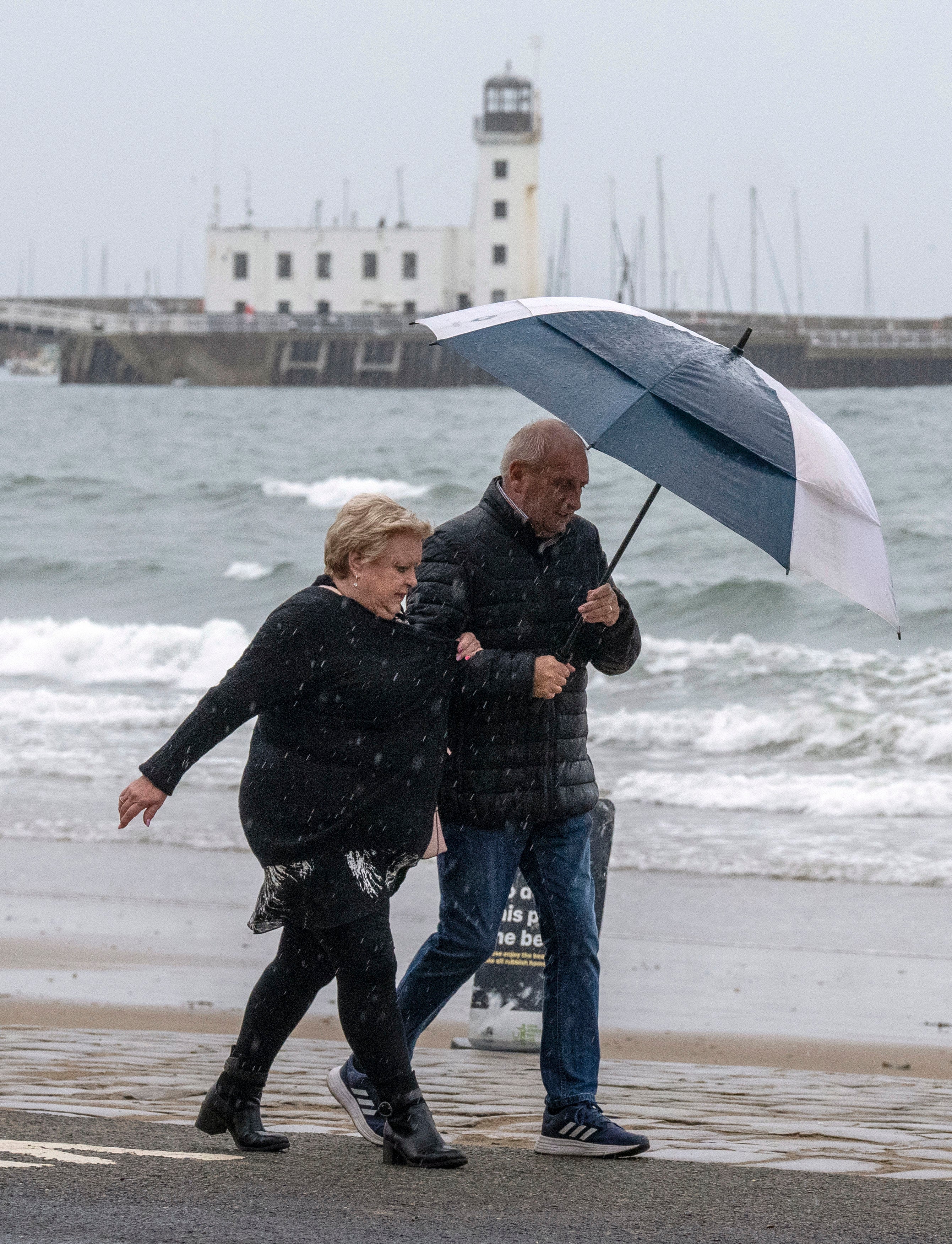 People walk along Scarborough sea front during Storm Agnes