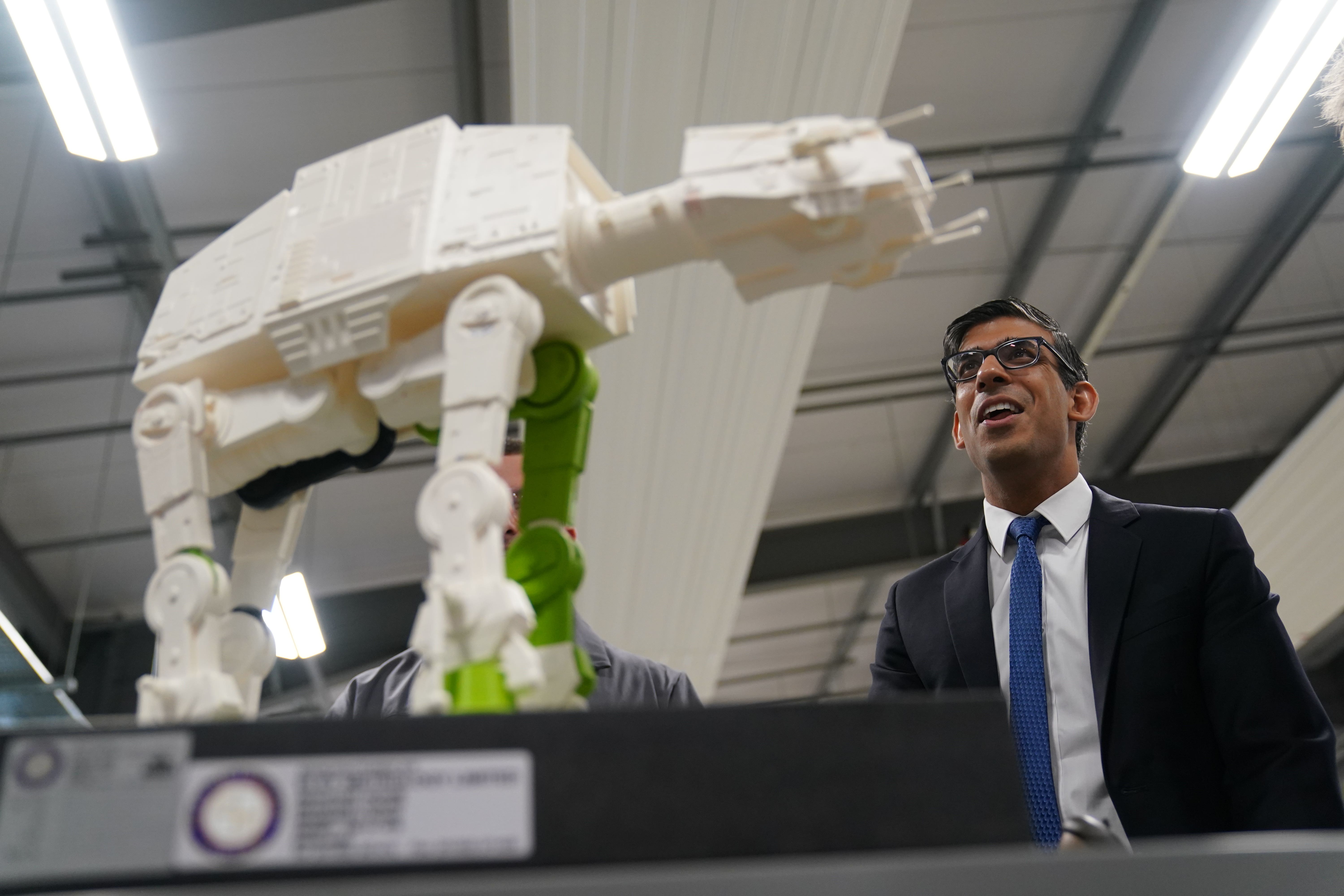 Star Wars fan Rishi Sunak is shown a 3D printed model of a transport walker from Star Wars, made by apprentices, during a visit to the UK Atomic Energy Authority in Oxfordshire (Jacob King/PA)