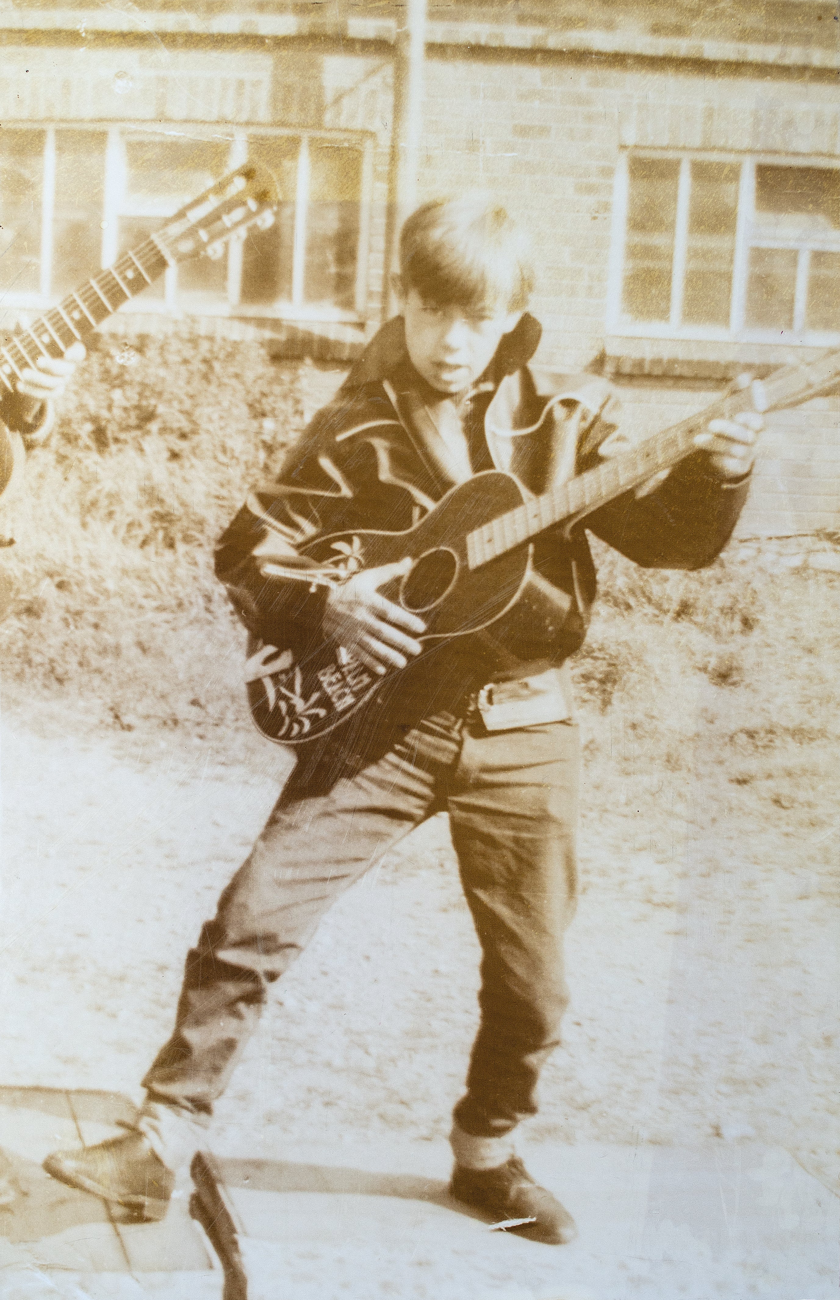 Bernie Taupin with his guitar as a child