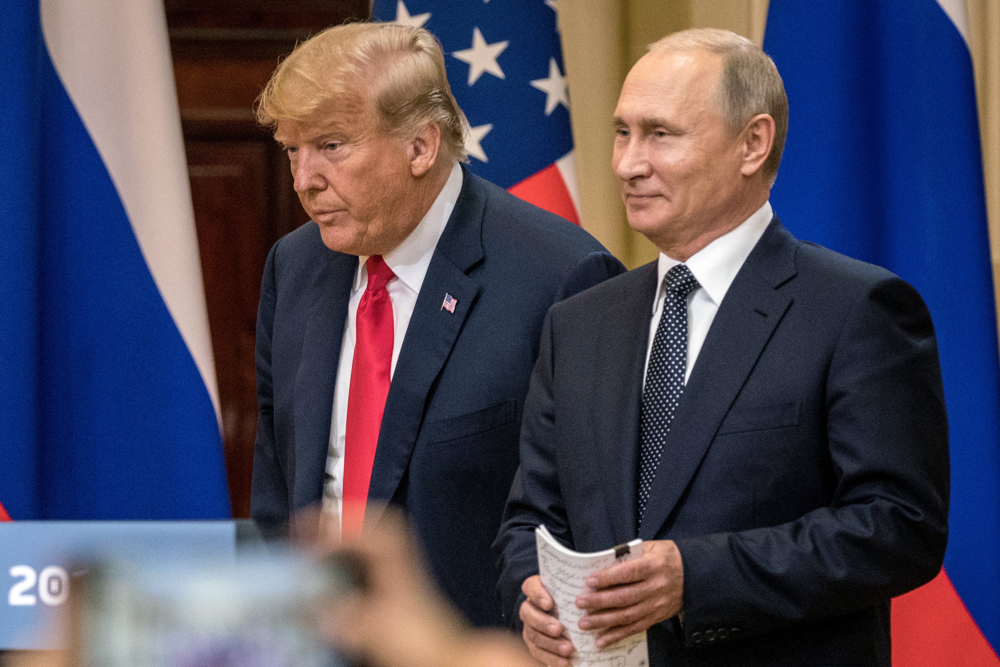 Donald Trump and Vladimir Putin arrive for a joint press conference after their summit on in Helsinki, Finland in July 2016