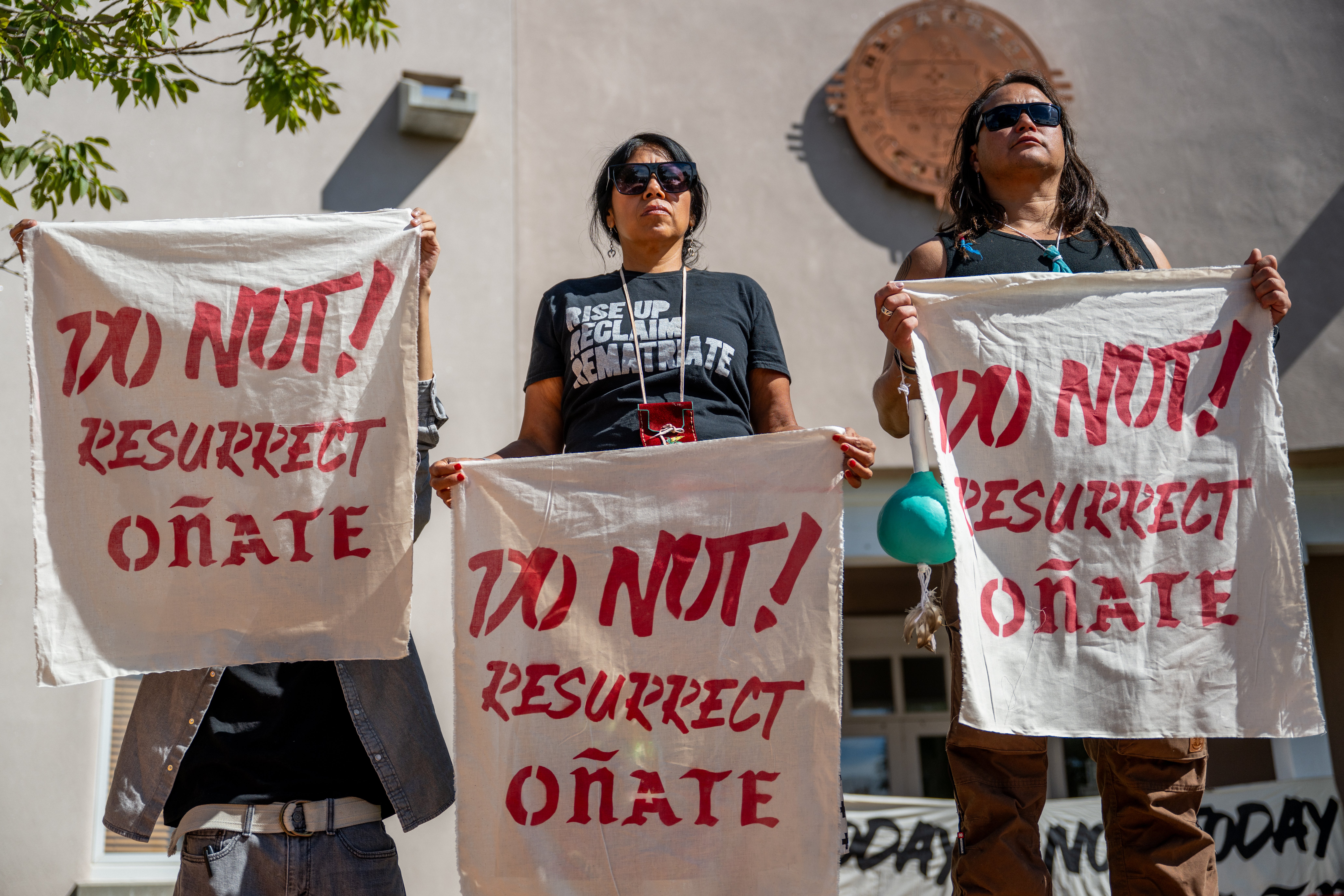 People gather in protest against the reinstallation of a 16th-century New Mexico conquistador statue at the Rio Arriba County building on 28 September 2023