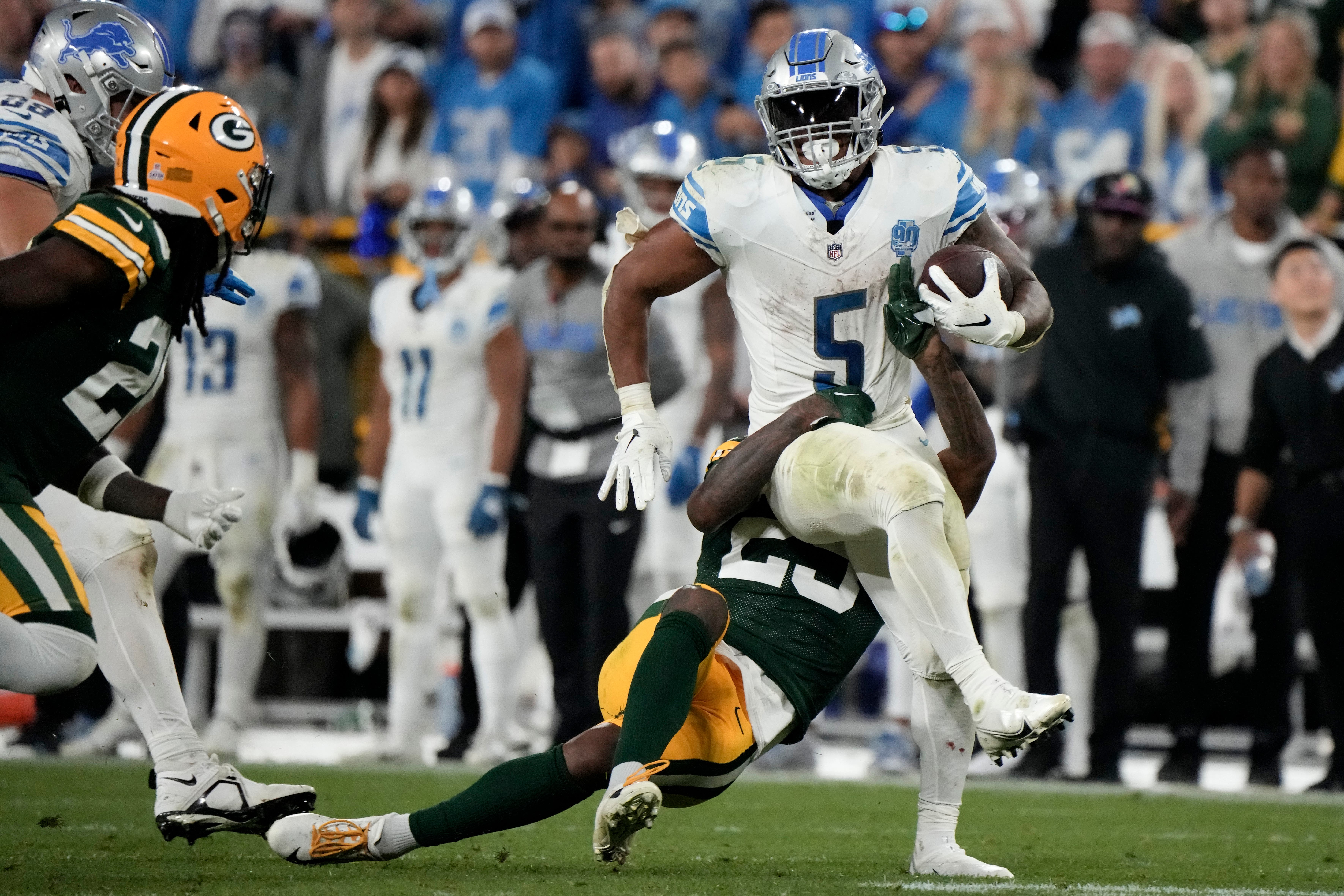 Detroit Lions running back David Montgomery (5) breaks a tackle by Green Bay Packers cornerback Rasul Douglas (29) (Morry Gash/AP)