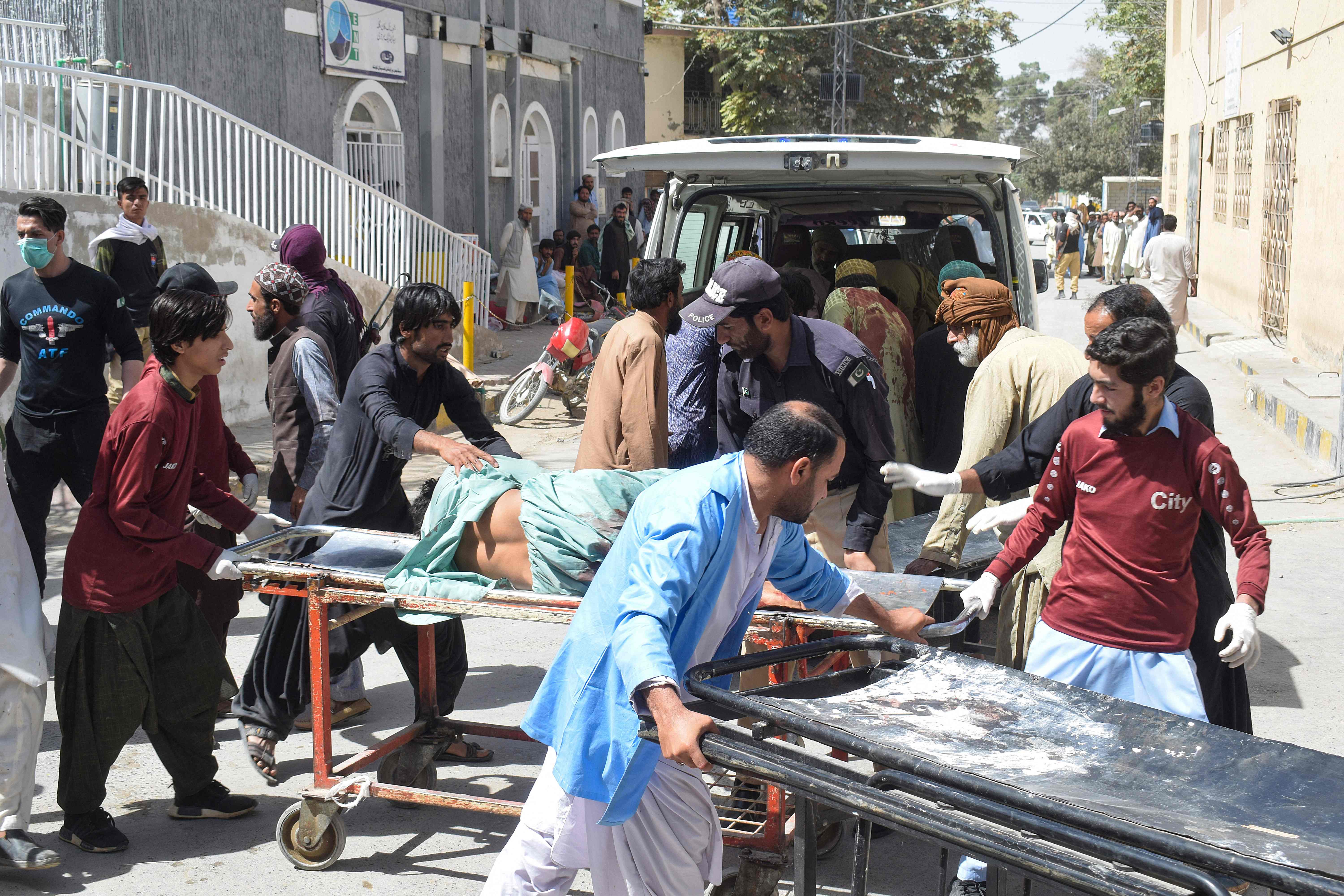 Volunteers carry a blast victim on a stretcher at a hospital in Quetta