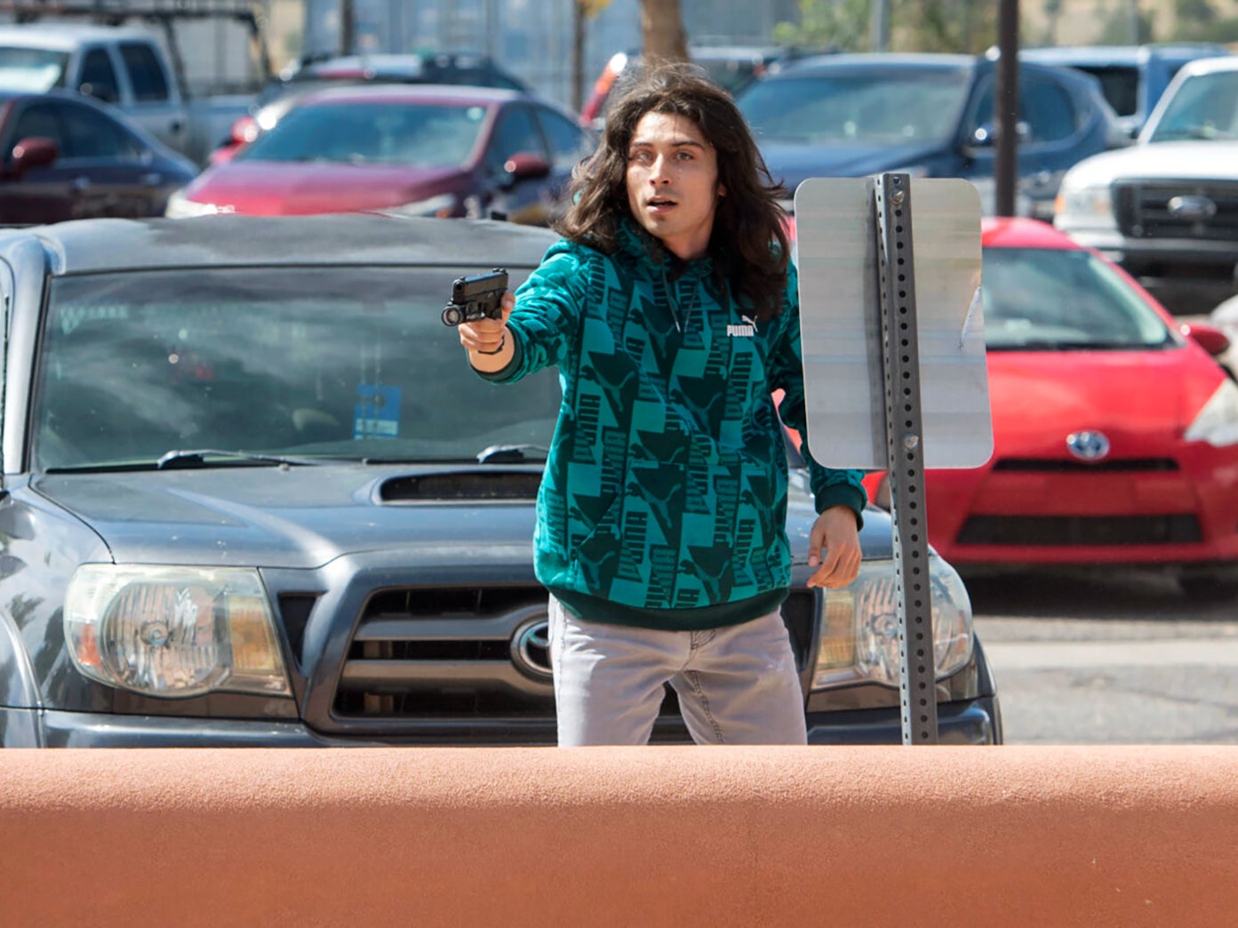 A man who identified himself to the Albuquerque Journal as Ryan Martinez, of East Mountains, pulls a gun during a rally