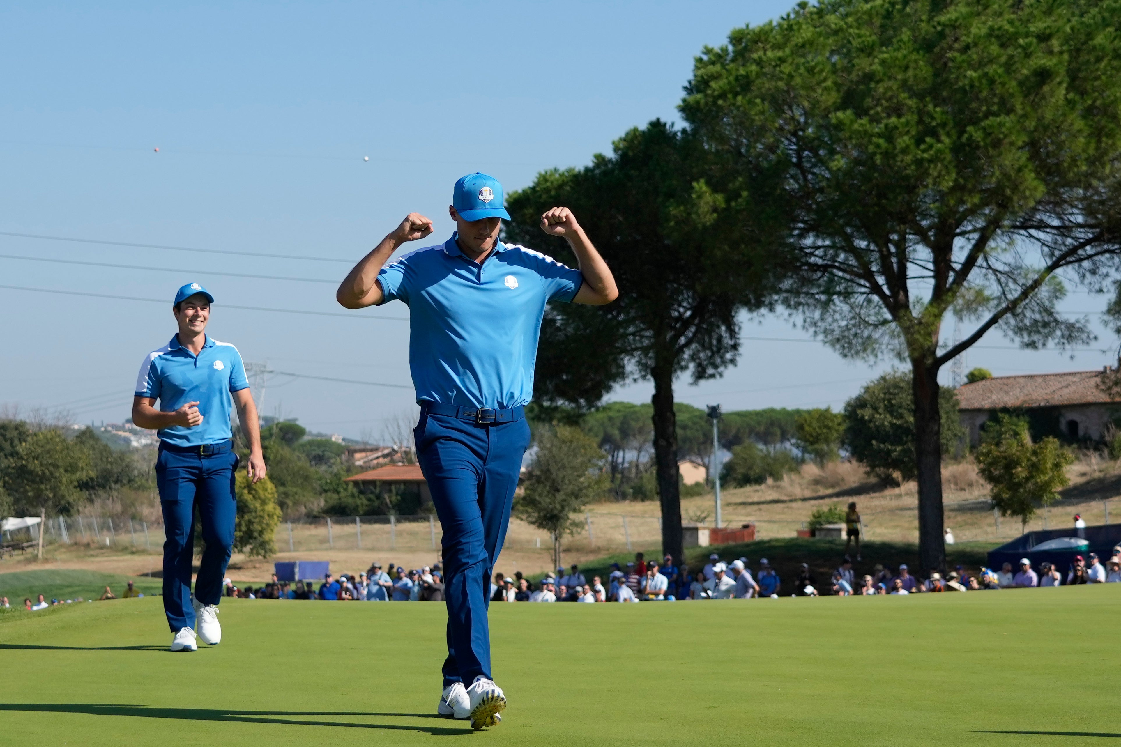 Aberg celebrates their winning moment on the 15th green