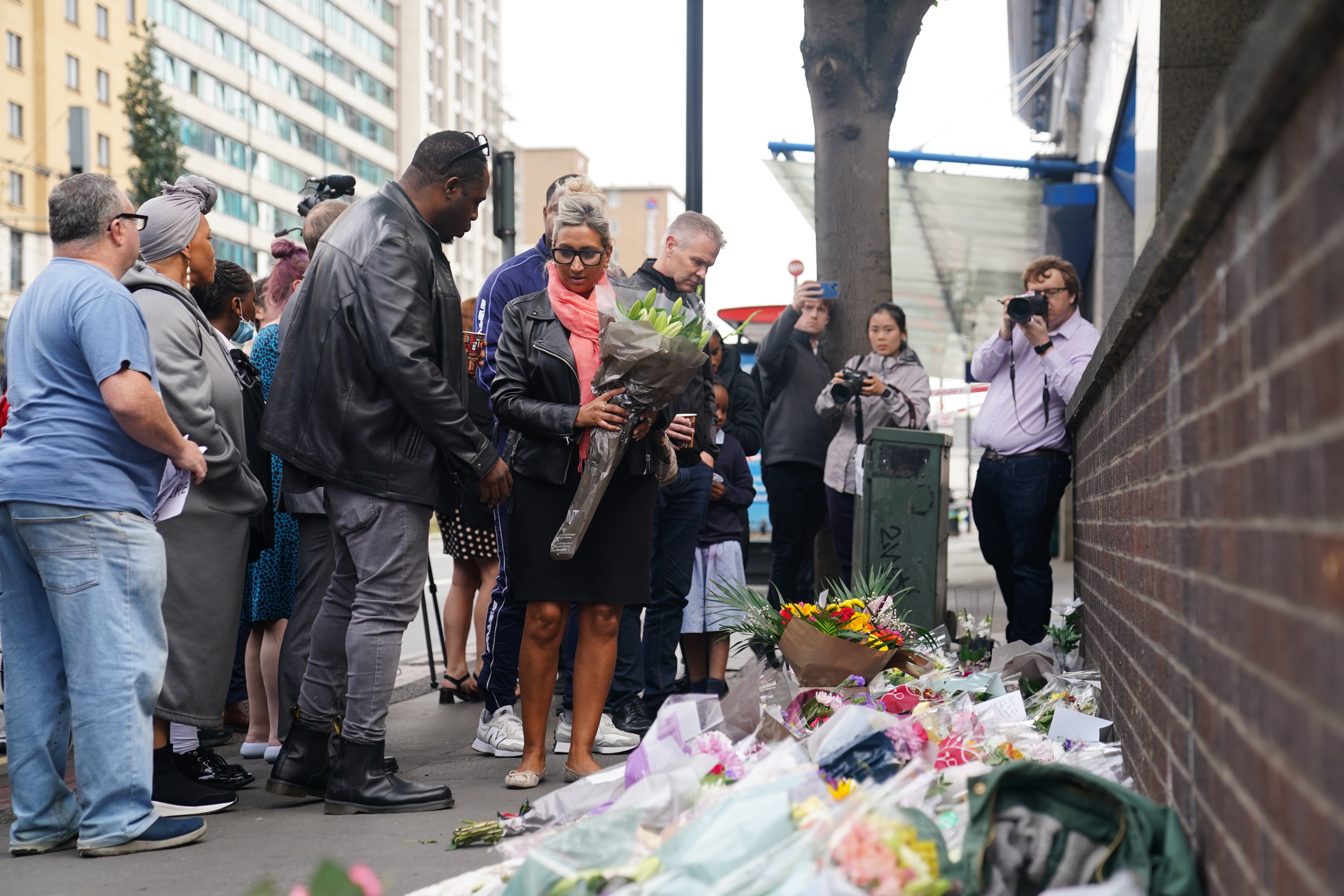 People laid flowers at the scene in Croydon, south London, where 15-year-old Elianne Andam was stabbed to death on Wednesday morning