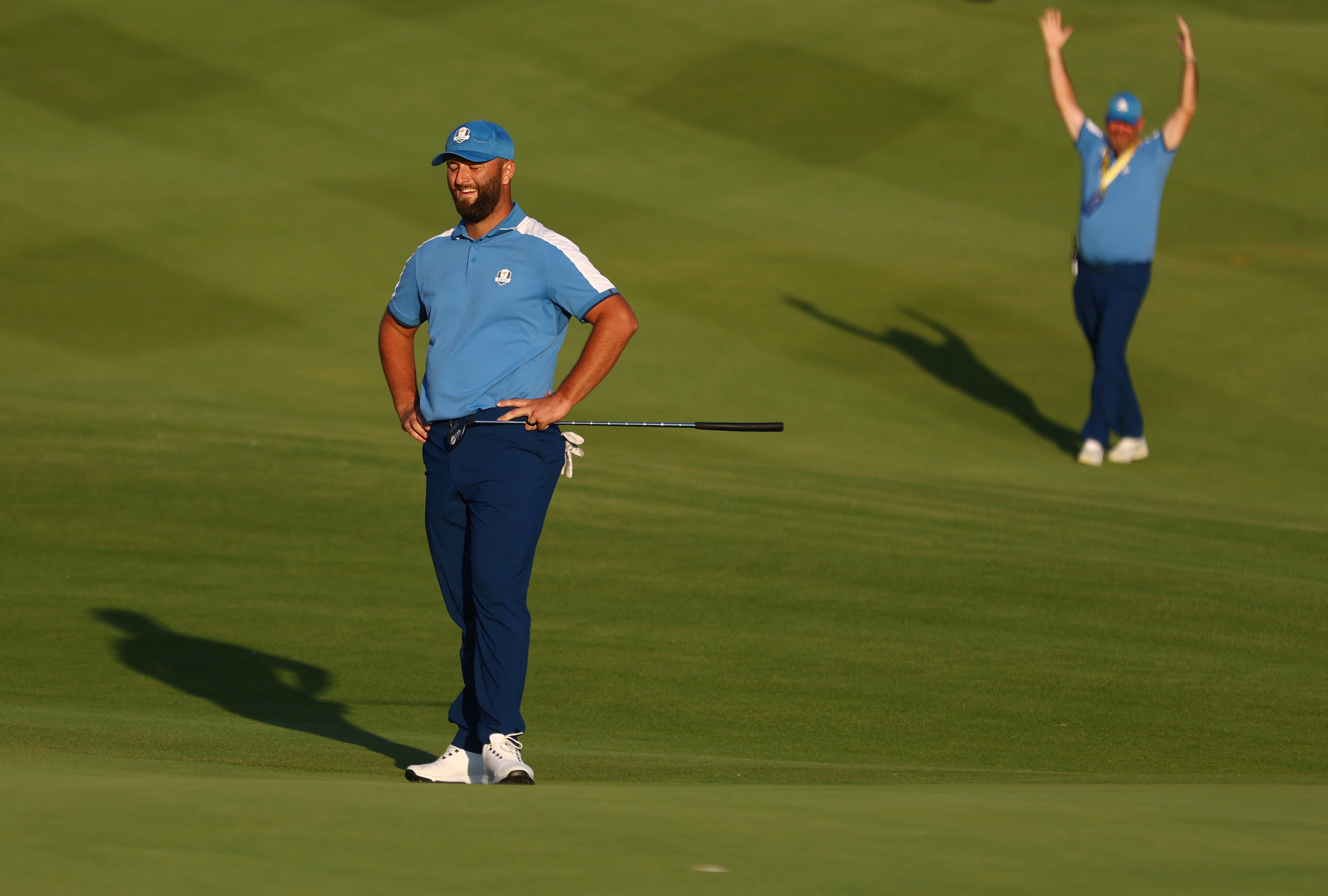 Rahm reacts as his putt drops on the 18th hole