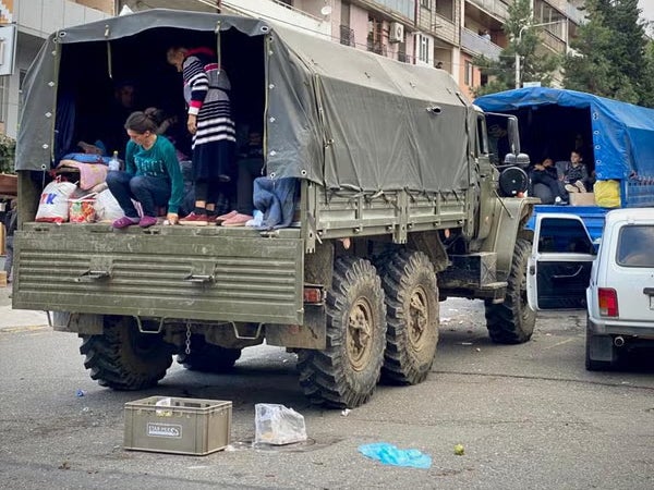 Families hitched lifts on the back of trucks as they fled Nagorno-Karabakh