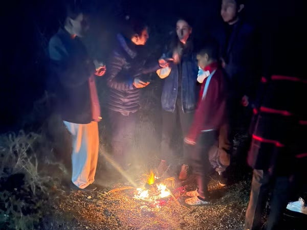 Families gather around a fire to make food in the journey out of Nagorno-Karabakh