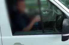 Truck driver takes both hands off steering wheel to drink cup of tea on M6