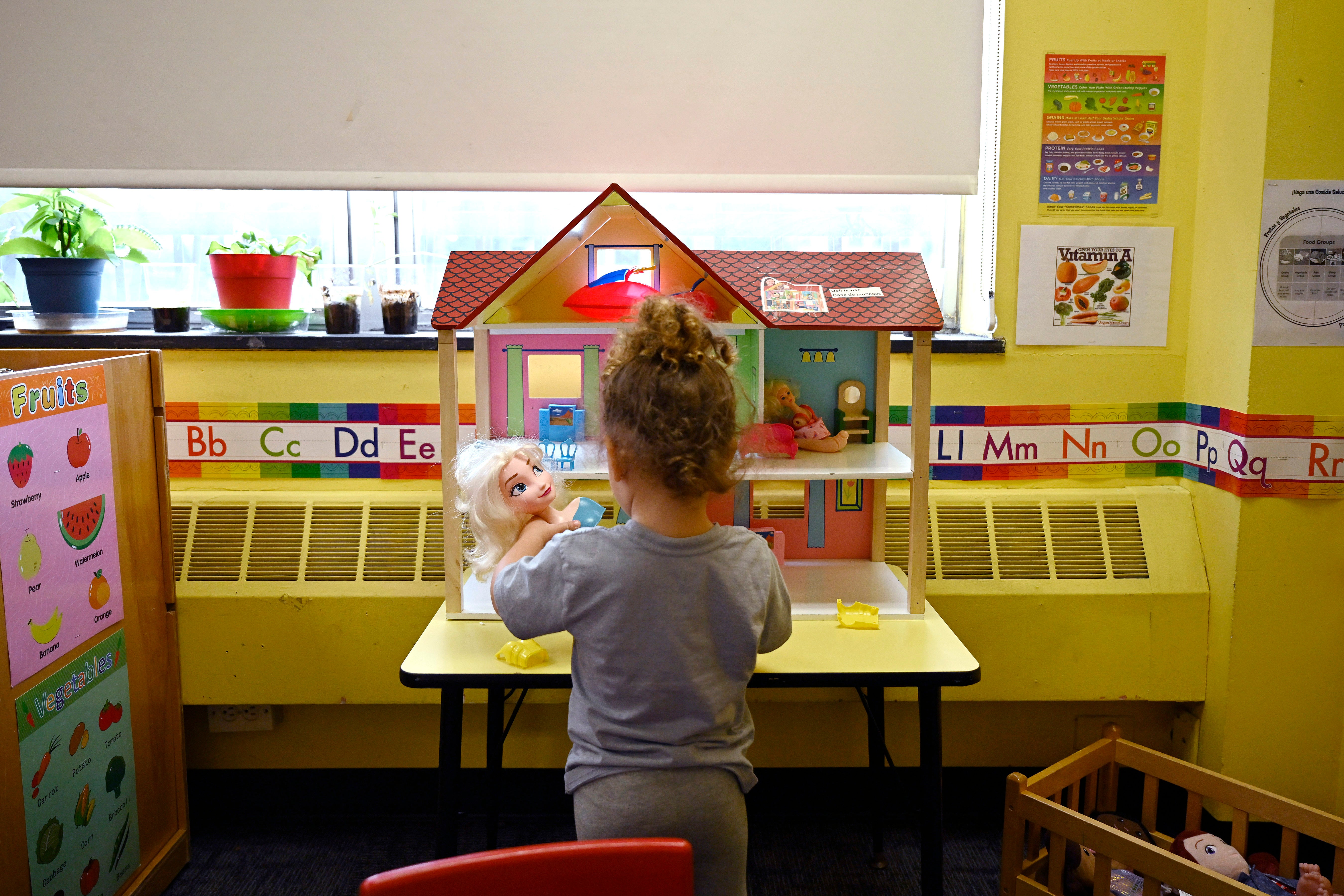 A child plays with dolls at a Head Start program at Alliance for Community Empowerment in Connecticut.