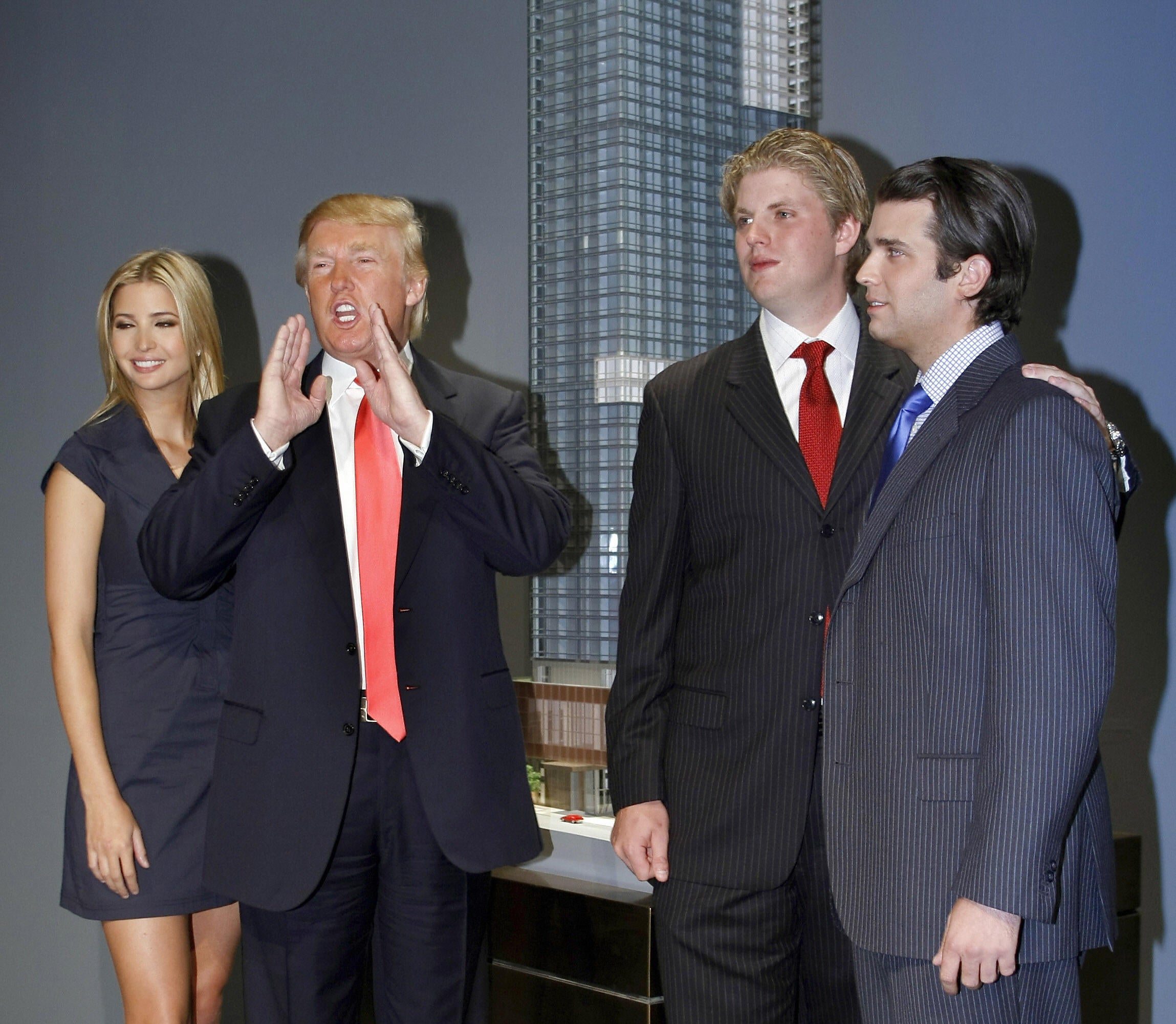 Donald Trump, with his oldest children Ivanka, Eric and Donald Jr, at a press conference announcing the launch of Trump SoHo Hotel Condominium in New York in 2007. The former president, his adult sons and business associates are accused of defrauding banks and insurers by overvaluing properties by billions of dollars